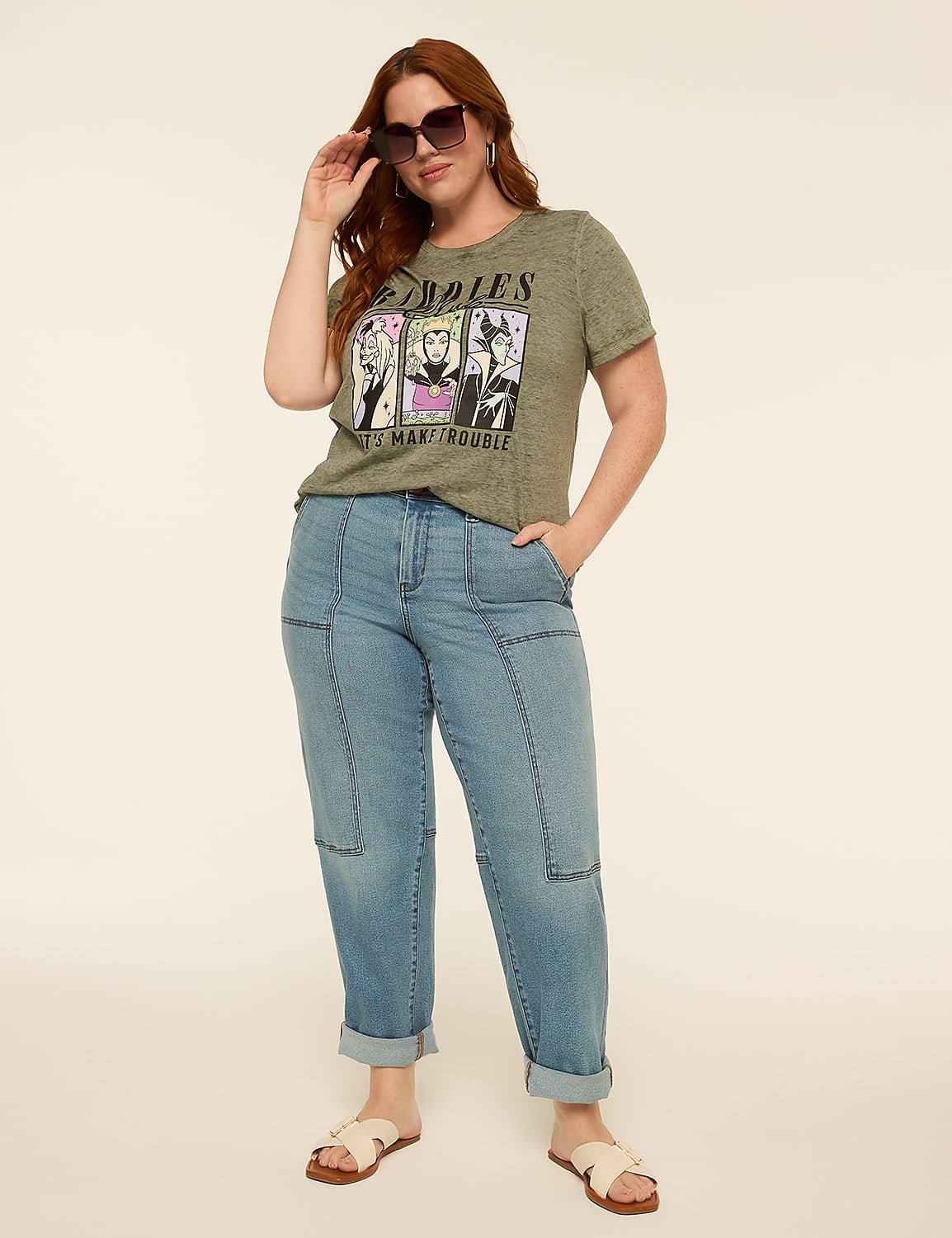 A woman in a graphic t-shirt and jeans stands against a plain, light-colored background. Product Image 3