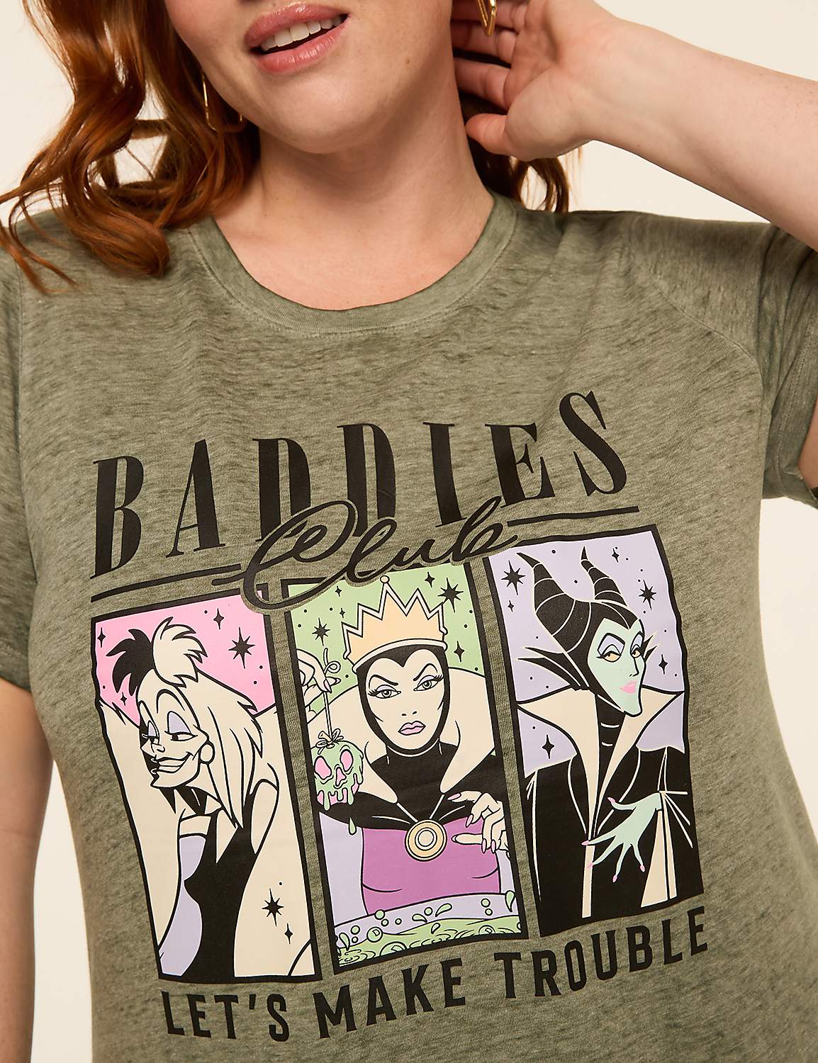 A woman in a green t-shirt with a graphic of three Disney villains and the text "Baddies Club Let's Make Trouble" is shown against a plain background. Product Image 4