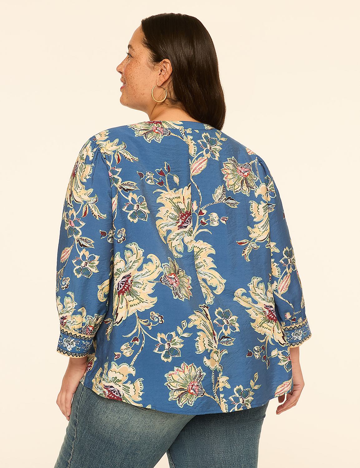 A woman in a blue floral blouse and jeans stands against a plain, light-colored background. Product Image 2