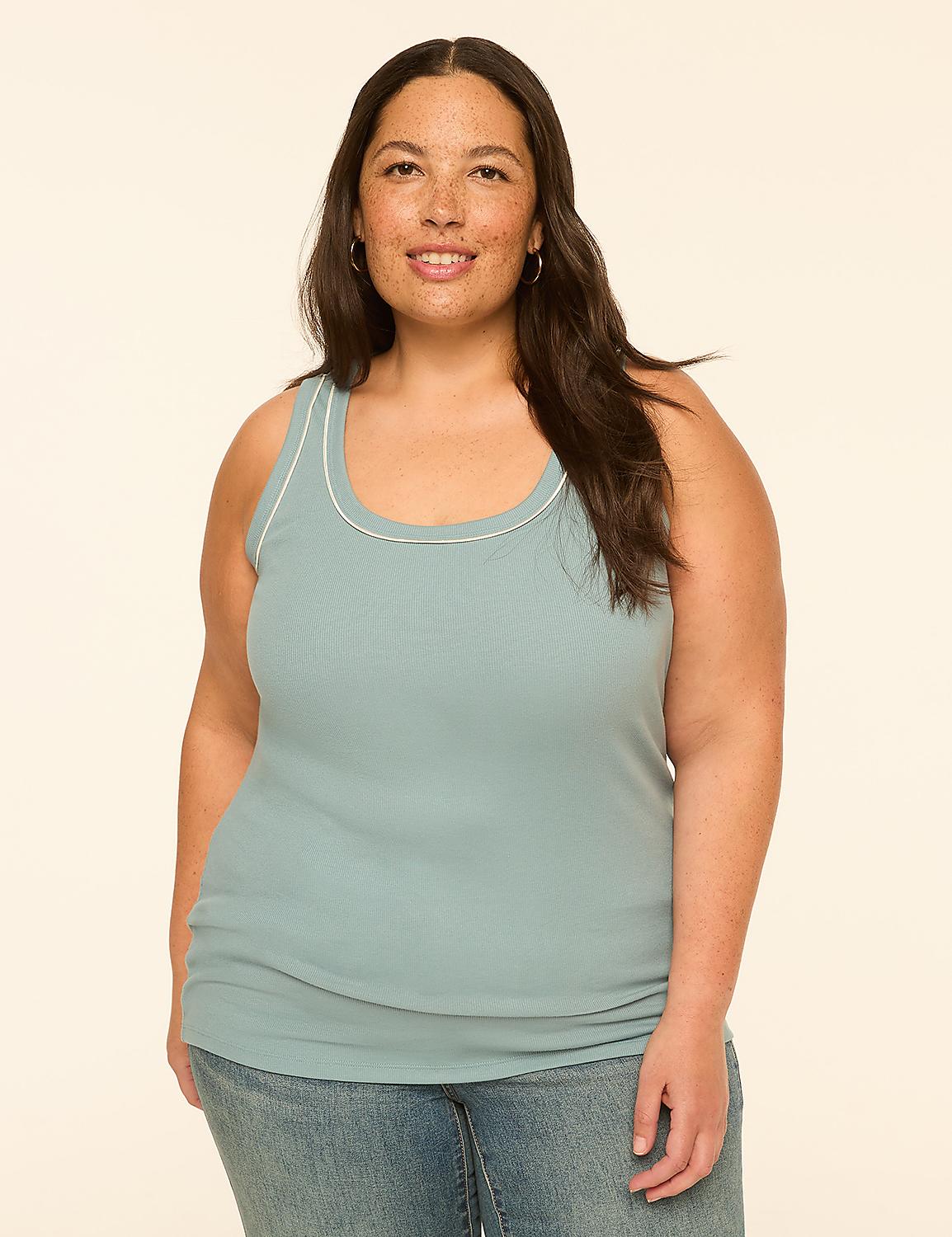A woman in a light blue tank top and jeans stands against a plain, light-colored background. Product Image 1
