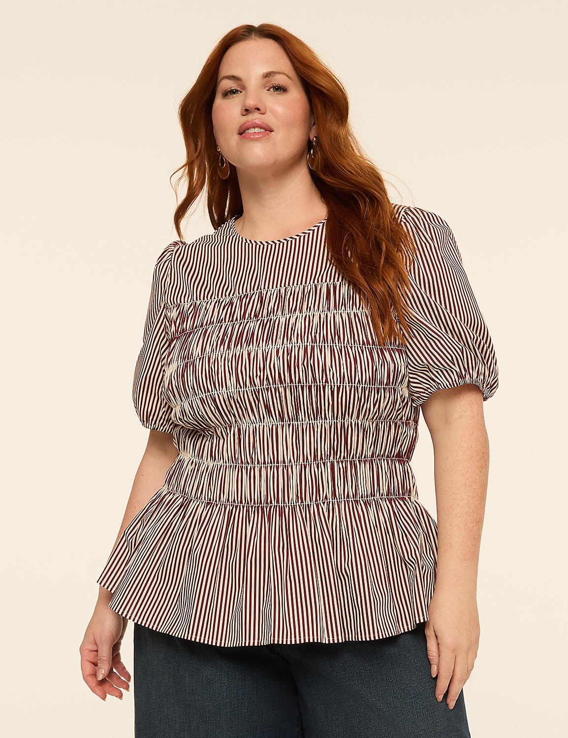 A woman with auburn hair and fair skin, wearing a red and white striped peplum top, poses against a plain, light-colored background. Product Image 1