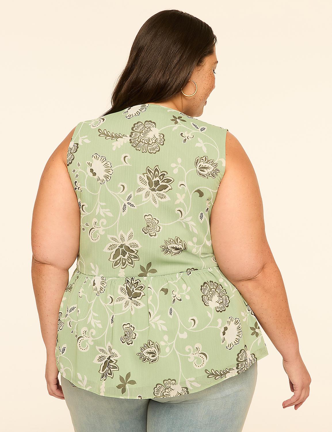 A woman in a floral peplum top stands against a plain, light-colored background. Product Image 2
