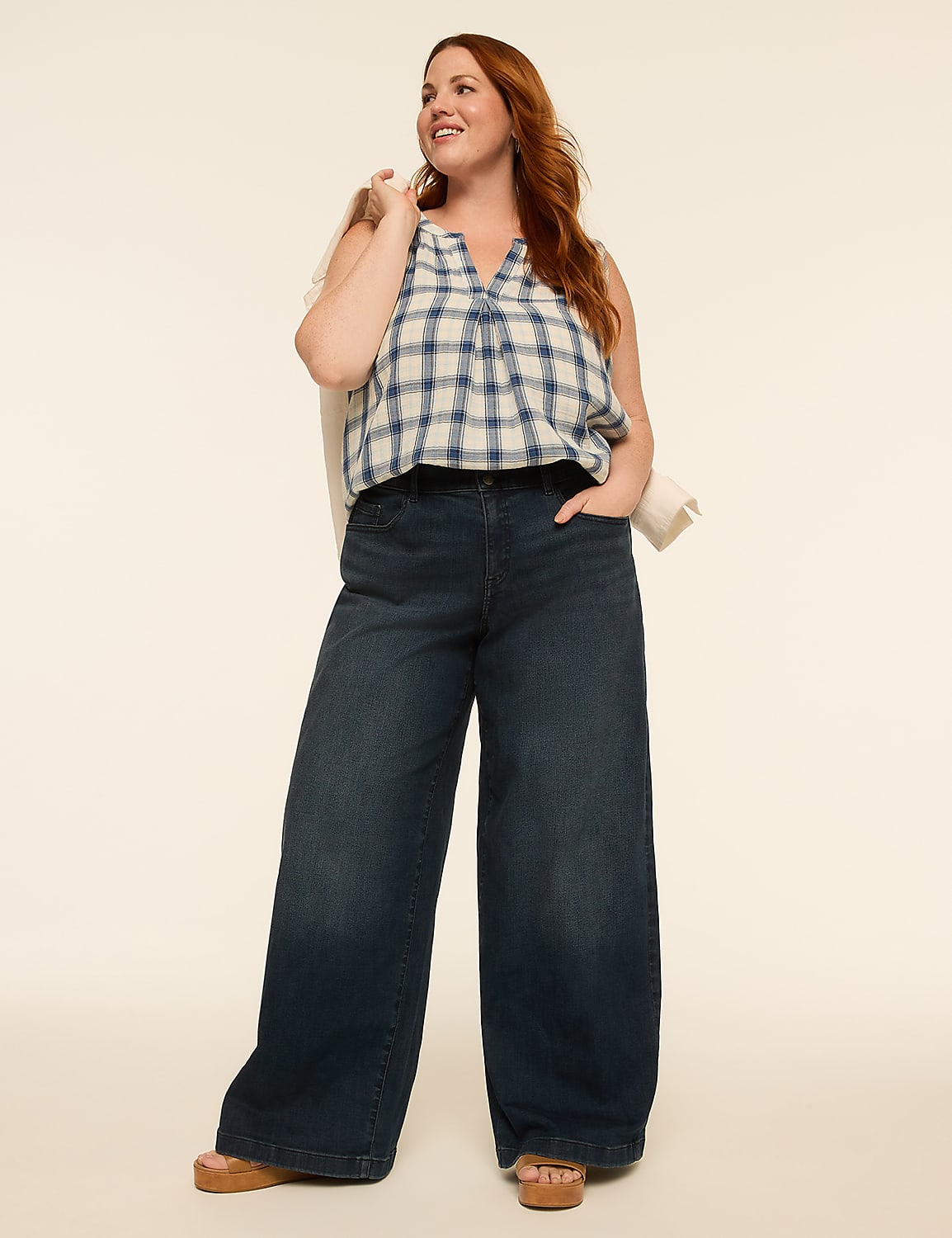 A woman in a plaid top and wide-leg jeans stands against a plain, light-colored background. Product Image 3