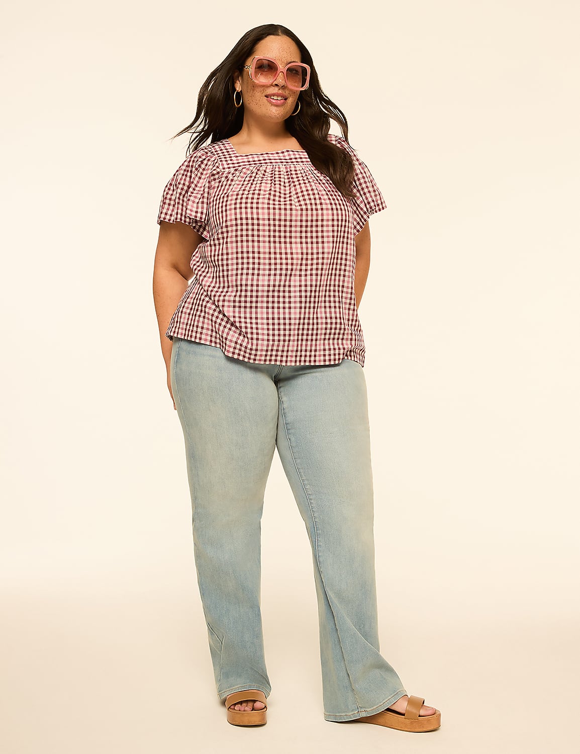 A woman in a pink plaid top and light wash jeans stands against a plain, light-colored background. Product Image 3