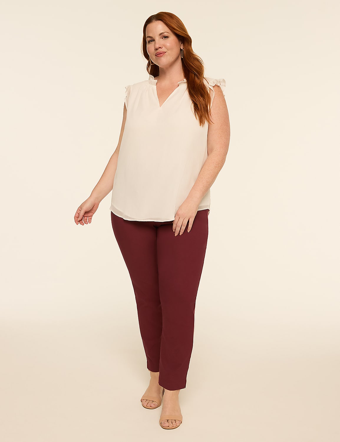 A woman in a cream-colored blouse and maroon pants stands against a plain, light-colored background. Product Image 3