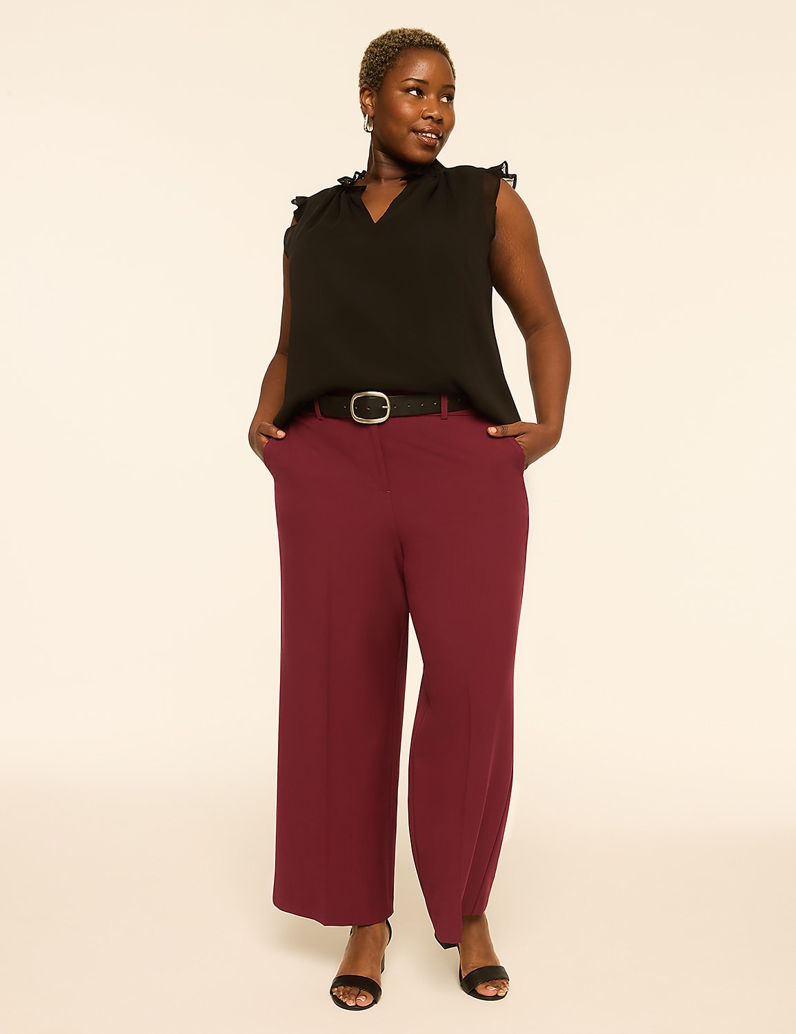 A woman in a black ruffled top and maroon wide-leg pants stands with her hands in her pockets against a plain, light-colored background. Product Image 3