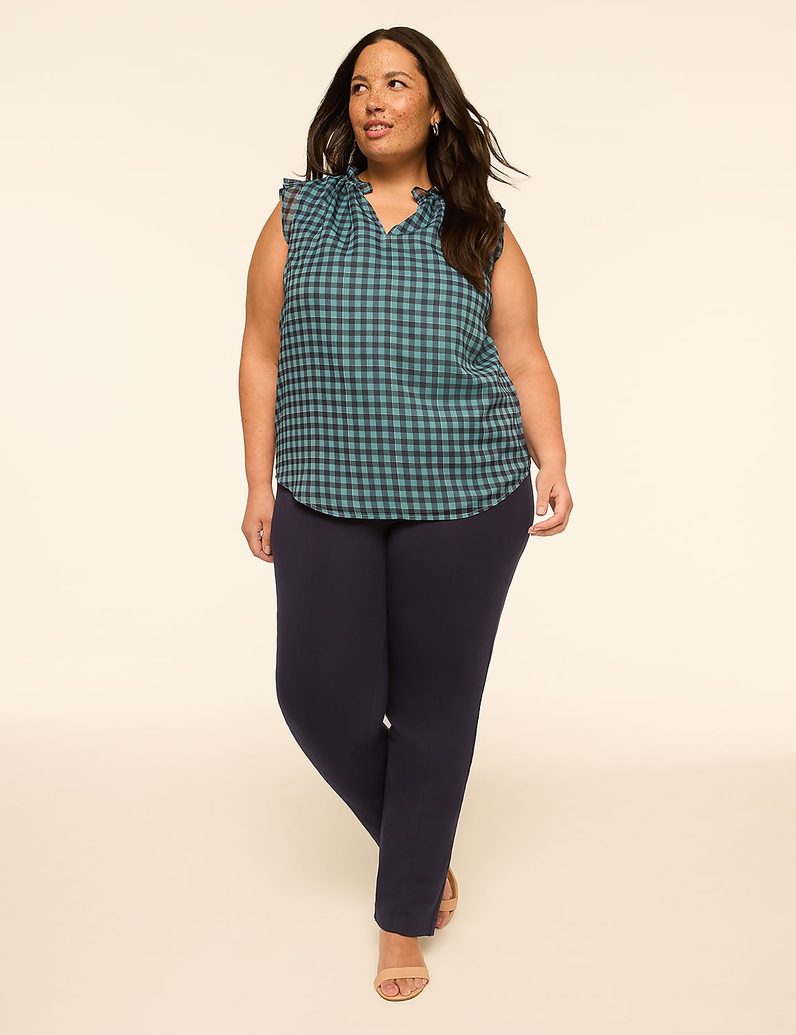 A woman in a blue checkered top and navy pants stands against a plain, light-colored background. Product Image 3