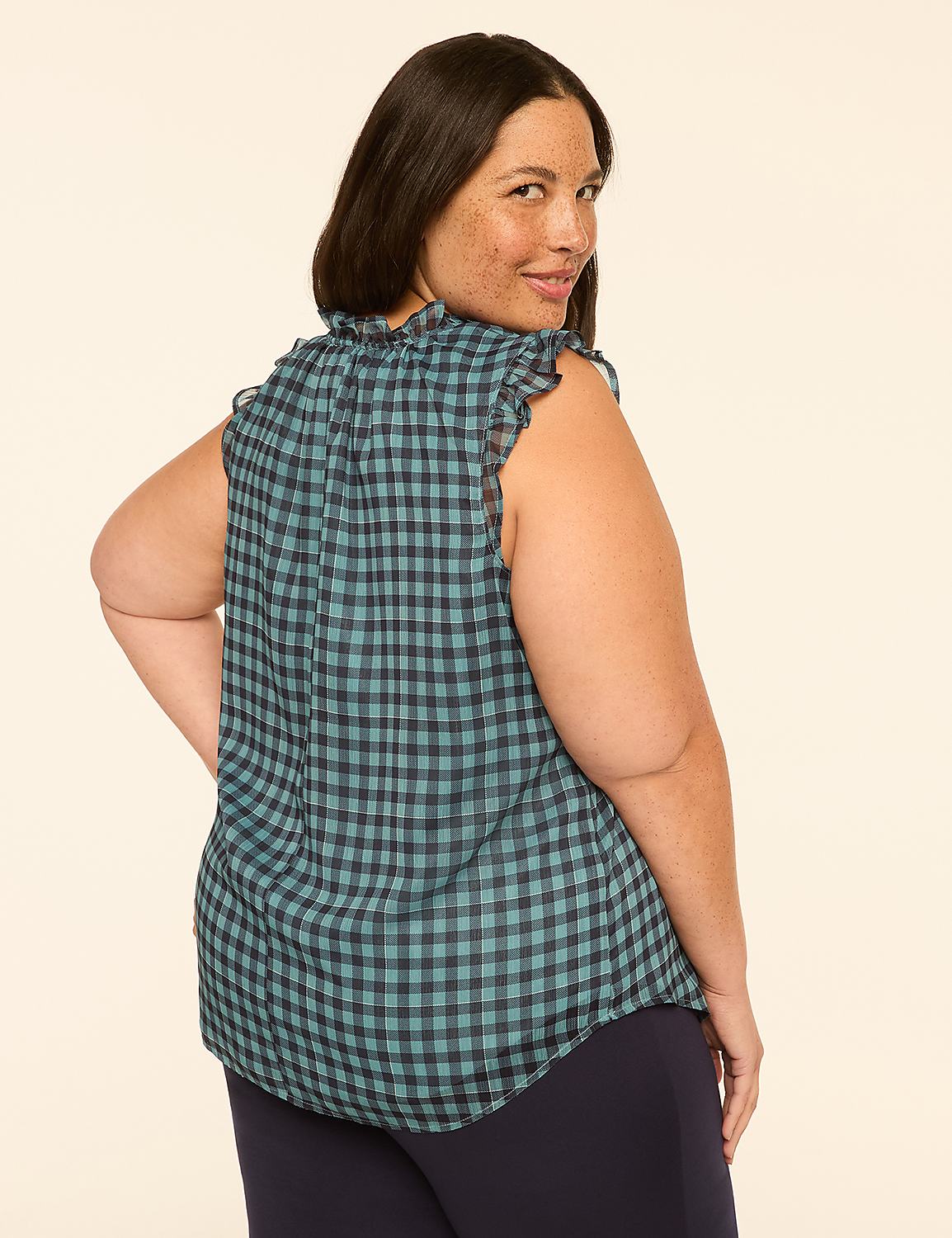 A woman in a teal gingham top and navy pants poses against a plain beige background. Product Image 2