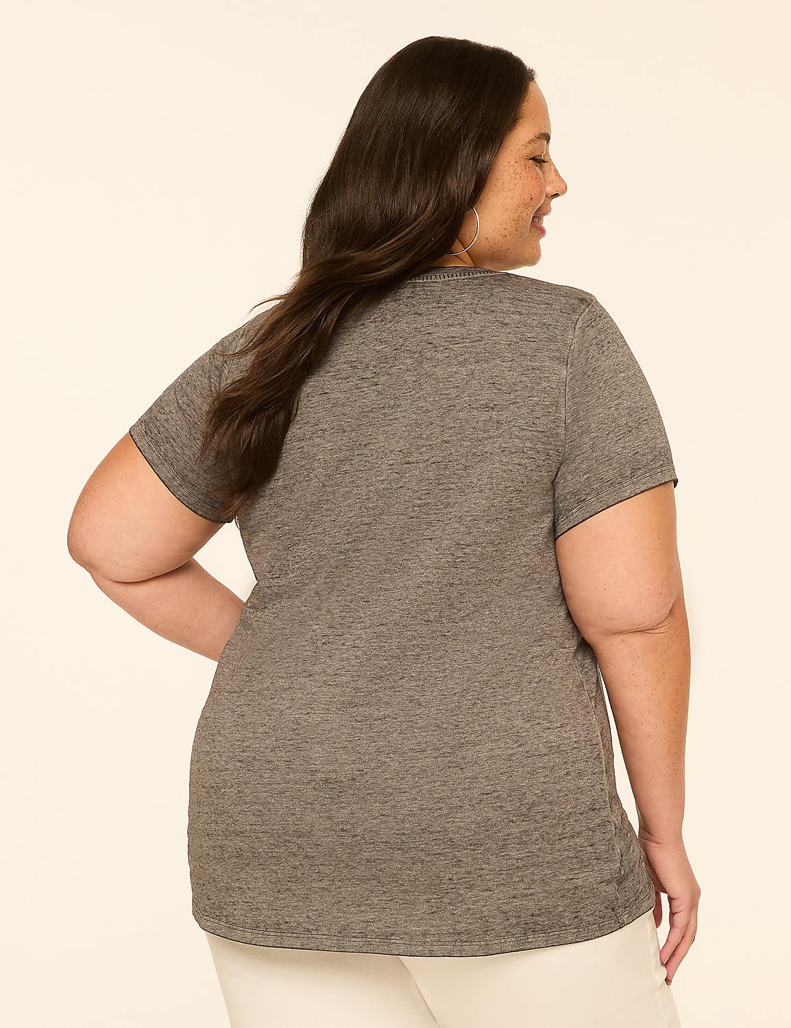 A woman in a grey t-shirt and white pants stands against a plain, light-colored background. Product Image 2