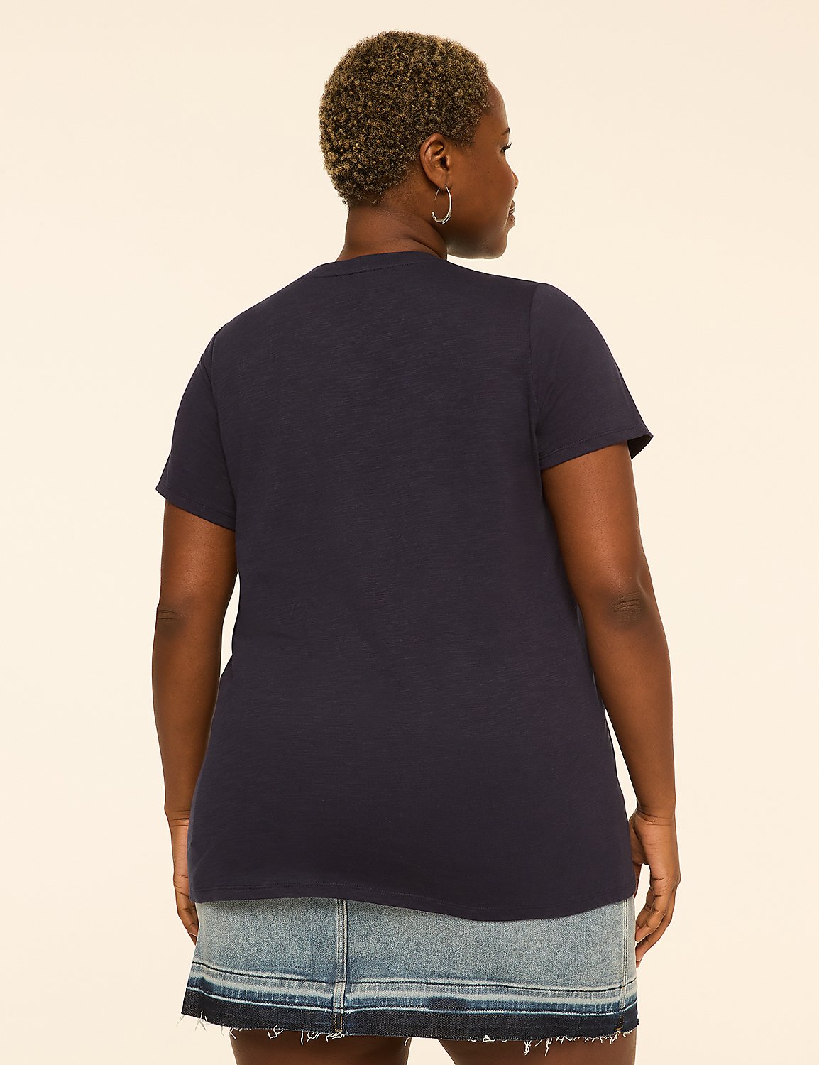 A woman in a navy t-shirt and denim skirt stands against a plain, light-colored background. Product Image 2