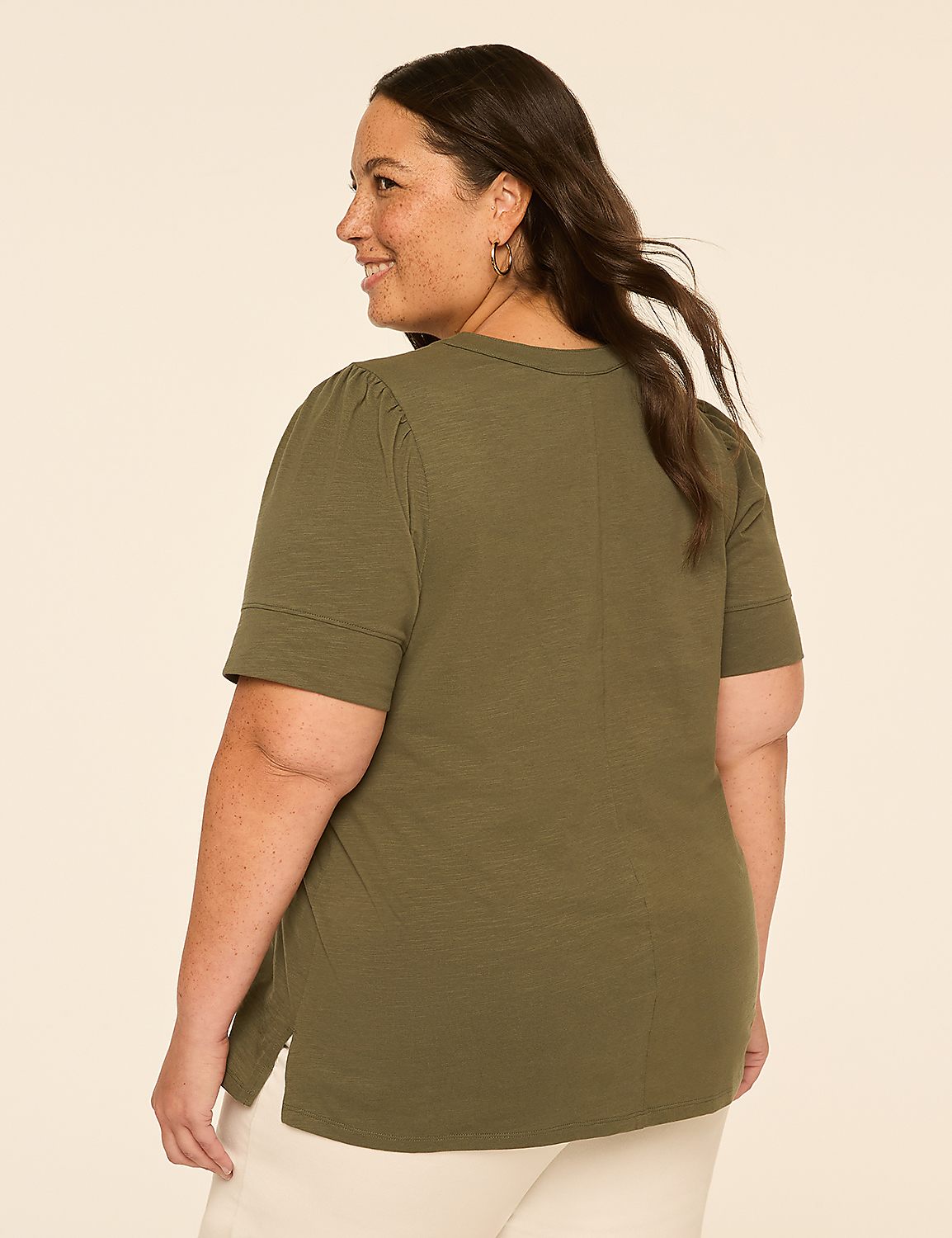 A woman in a green t-shirt stands against a plain, light-colored background. Product Image 2