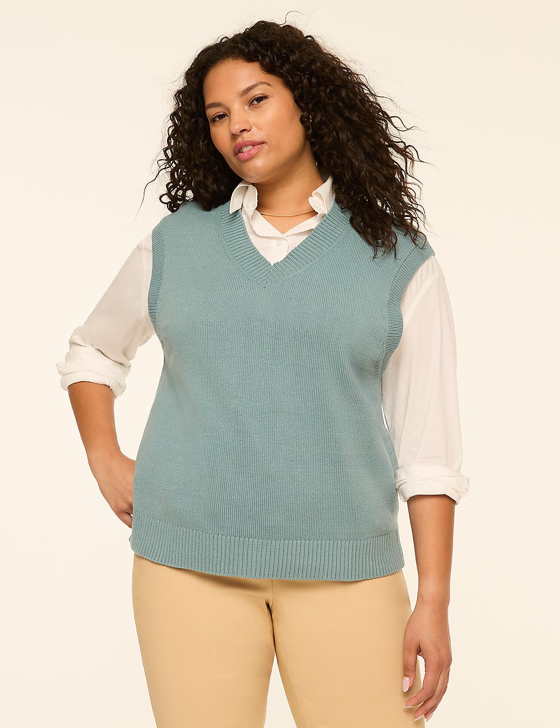 A woman in a teal v-neck sweater vest over a white collared shirt and tan pants stands against a plain cream background. Product Image 4