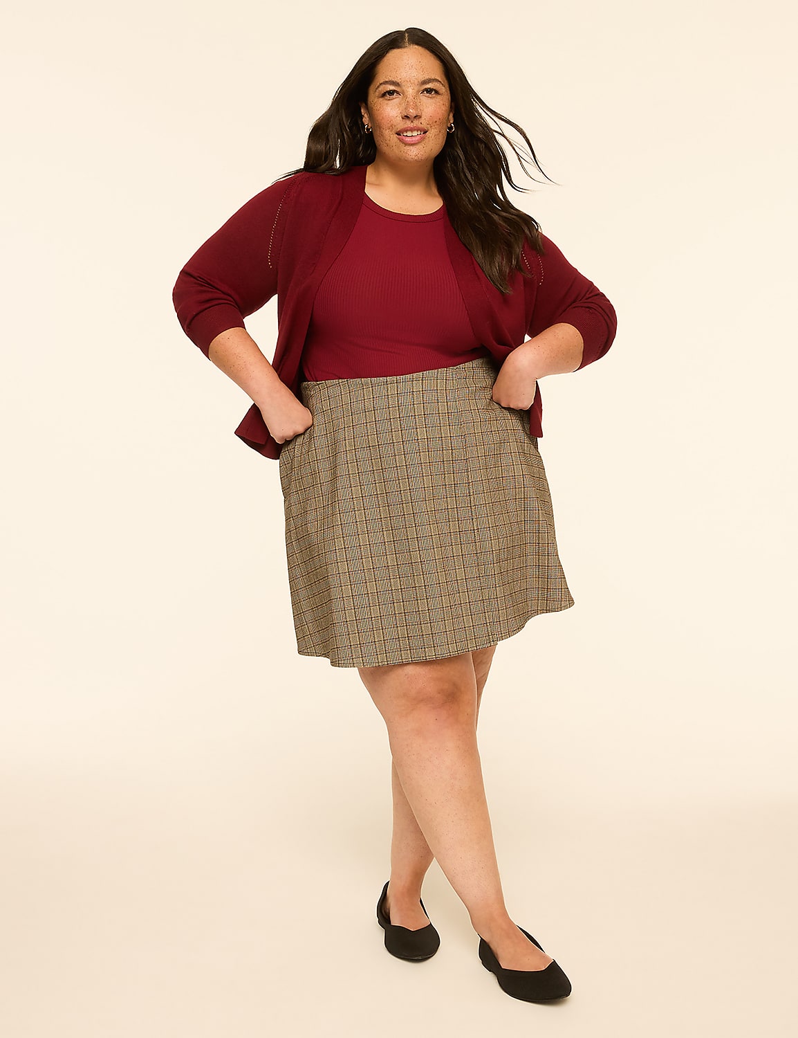 A woman in a maroon top and patterned skirt stands against a plain, light-colored background. Product Image 3