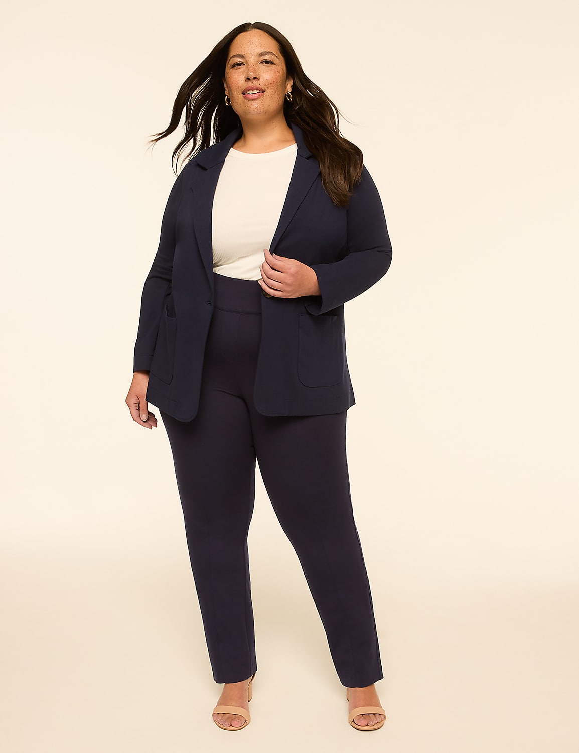 A woman in a navy blazer and pants stands against a plain, light-colored background. Product Image 3