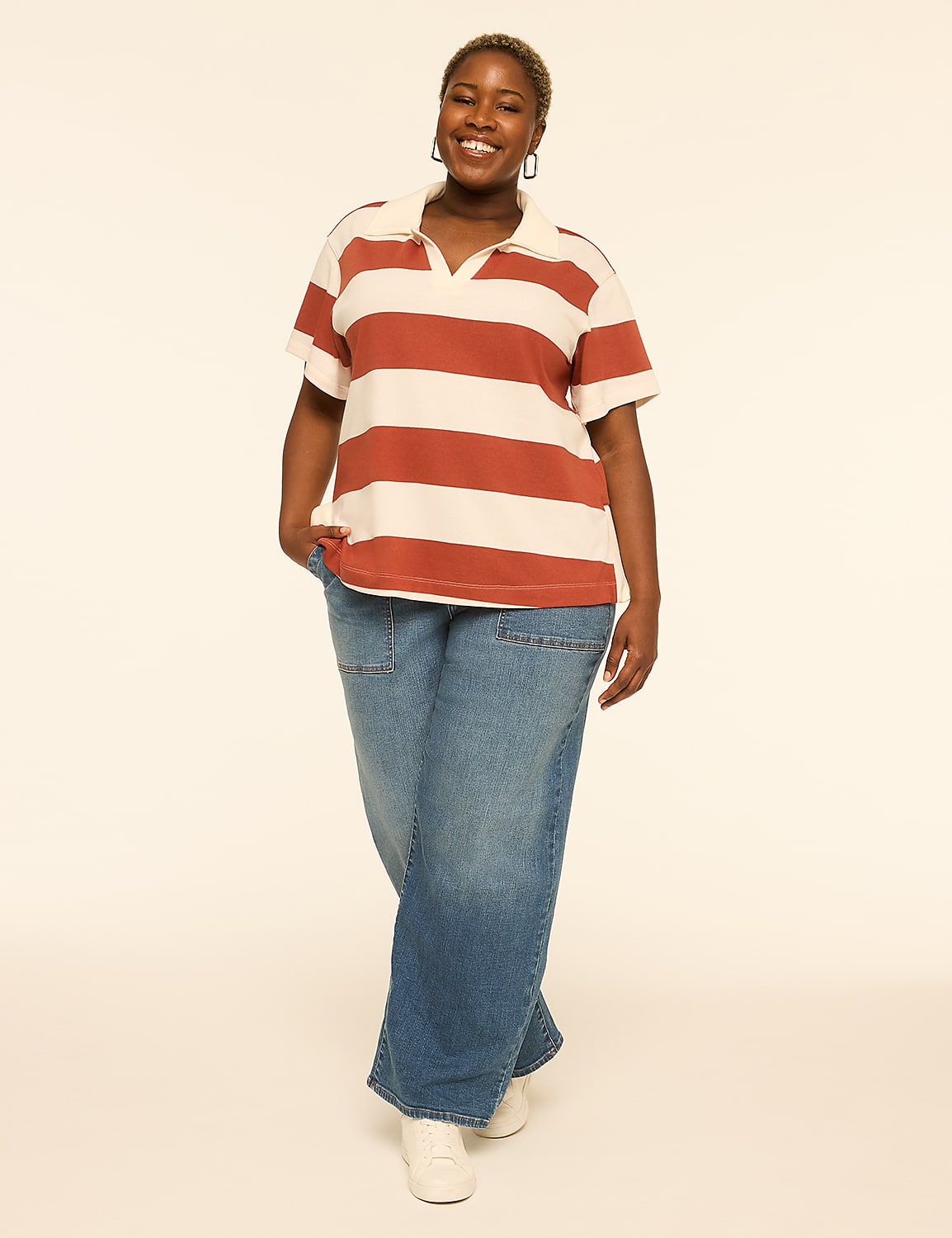 A smiling woman in a striped polo shirt and wide-leg jeans stands against a plain, light-colored background. Product Image 3