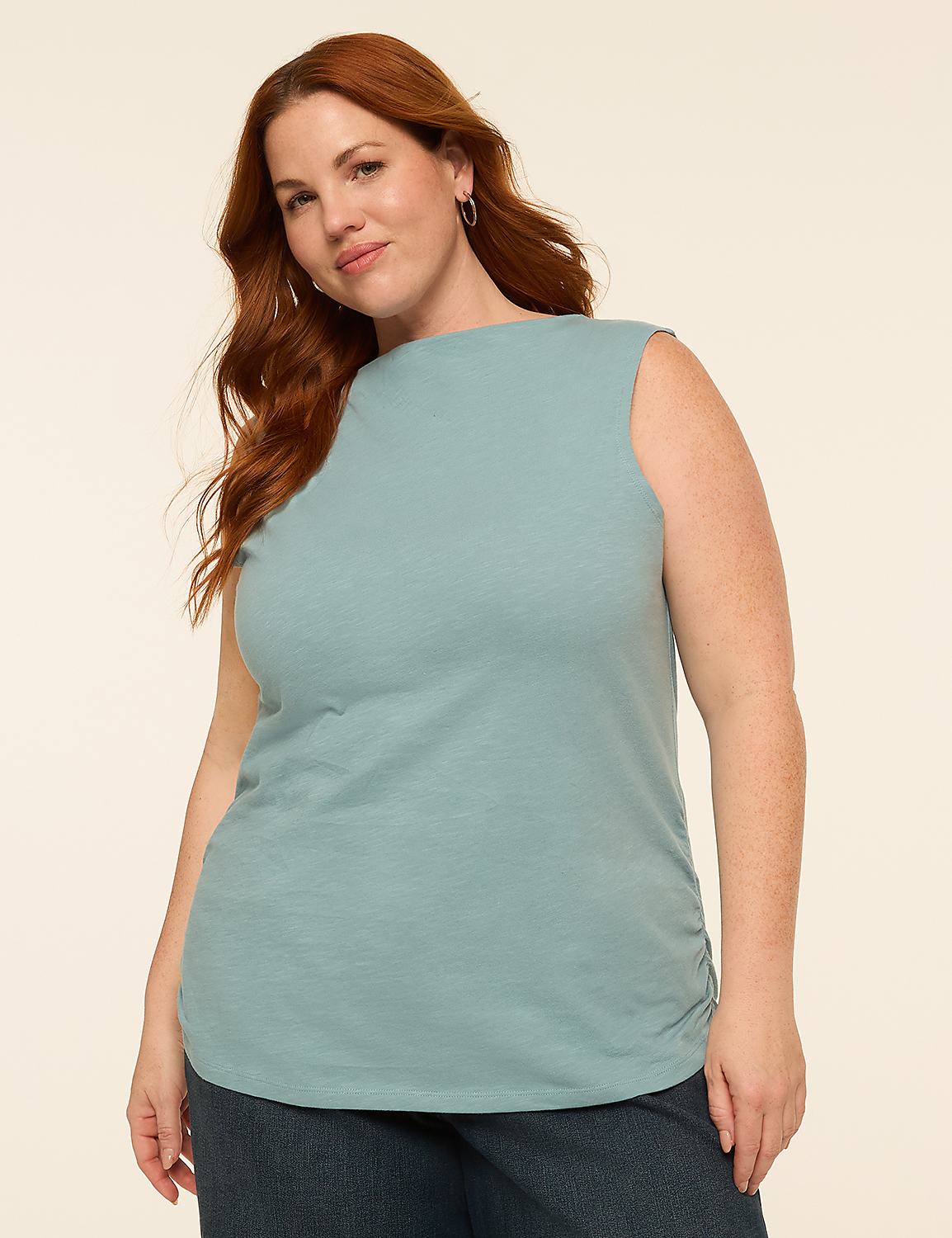 A woman with red hair stands in the foreground against a plain, light-colored background. Product Image 1