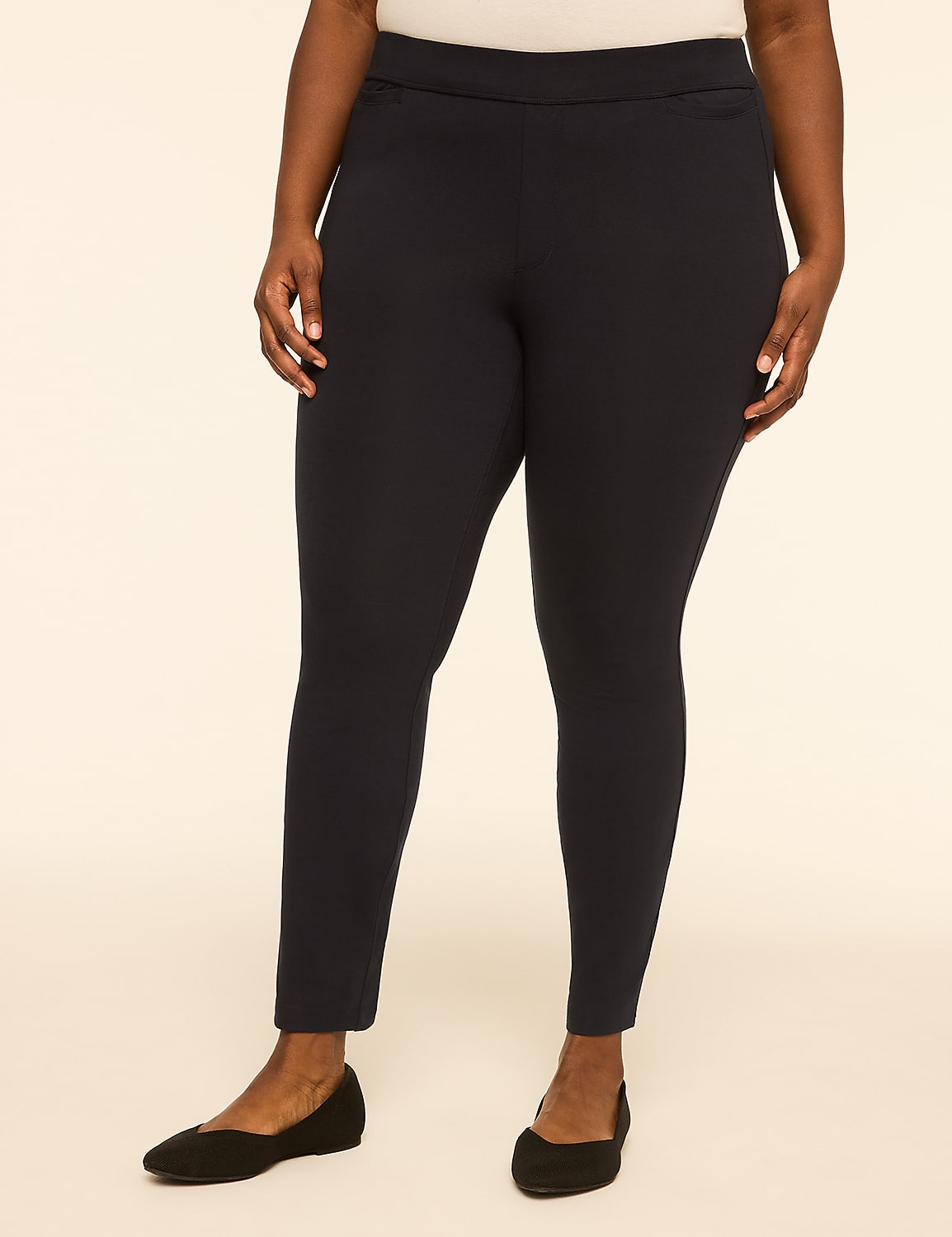 A person in dark leggings and black flats stands against a plain, light-colored background. Product Image 1