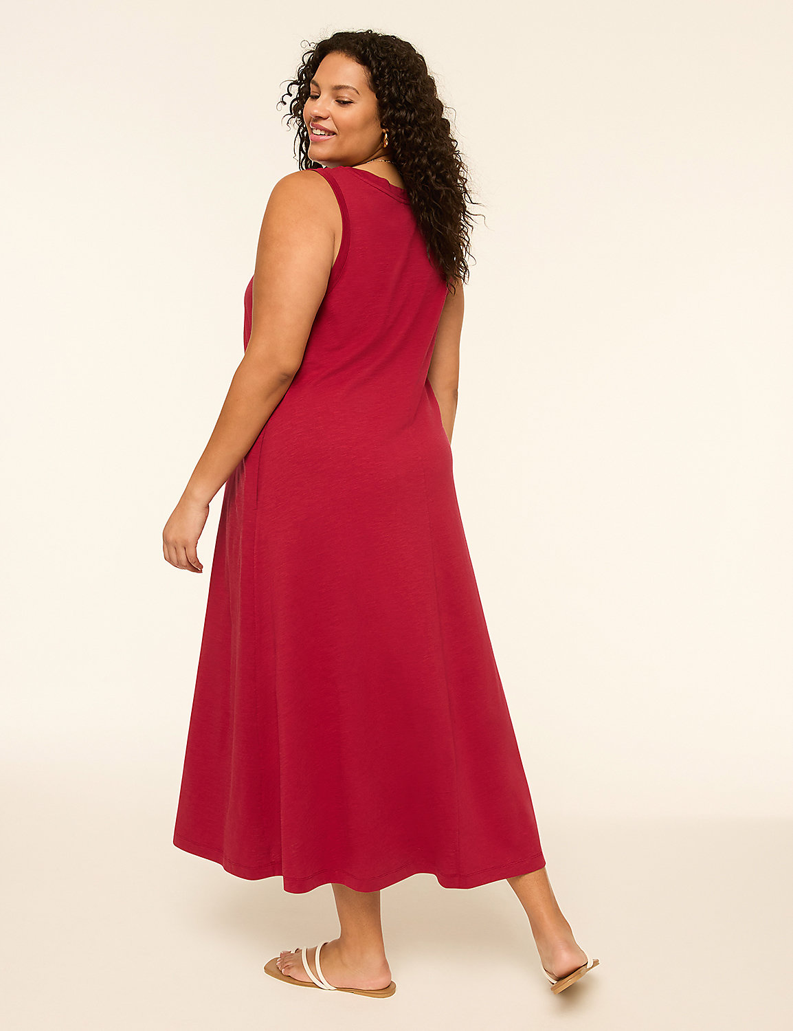 A woman in a red dress and sandals stands against a plain, light-colored background. Product Image 2