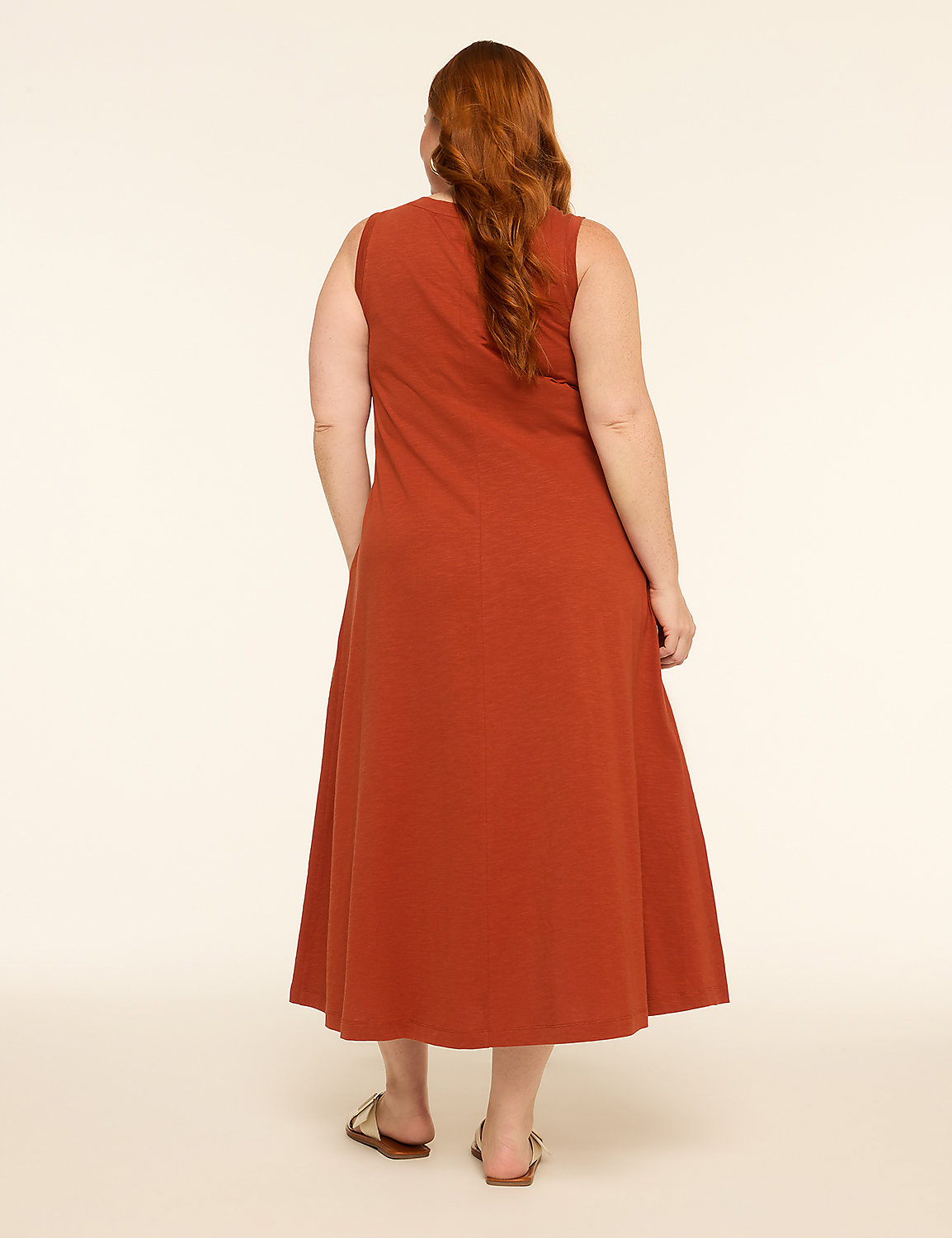 A woman in a rust-colored dress stands against a plain, light-colored background. Product Image 2