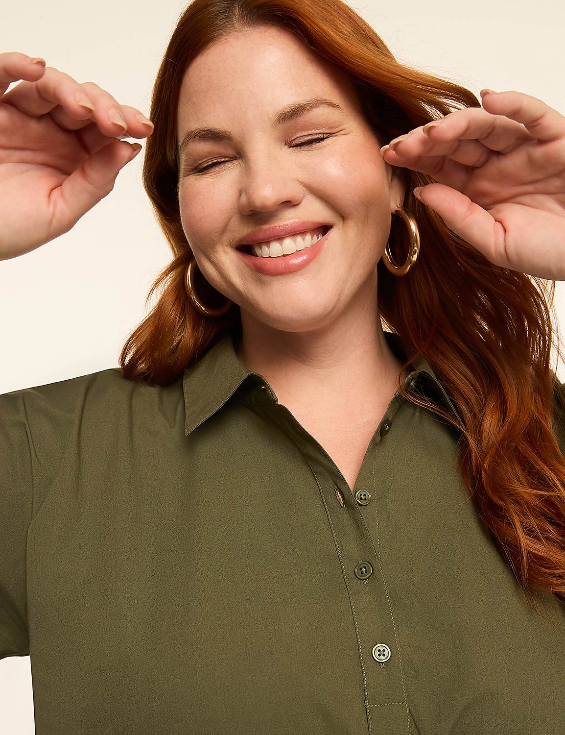 A smiling woman with red hair and hoop earrings in a green shirt is shown against a plain, light background. Product Image 3