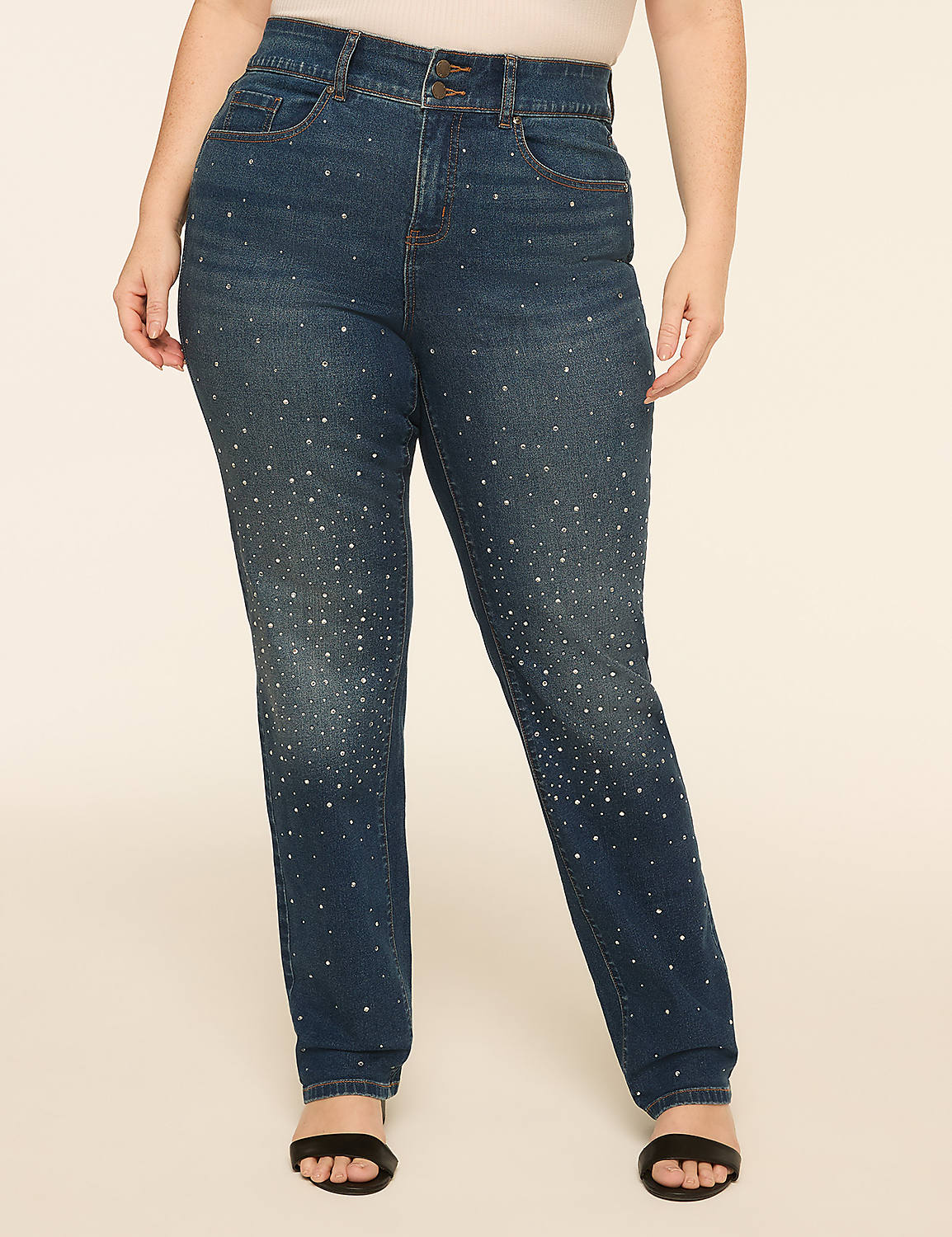 A person stands in the foreground wearing embellished denim jeans and black sandals, against a plain, light-colored background. Product Image 1