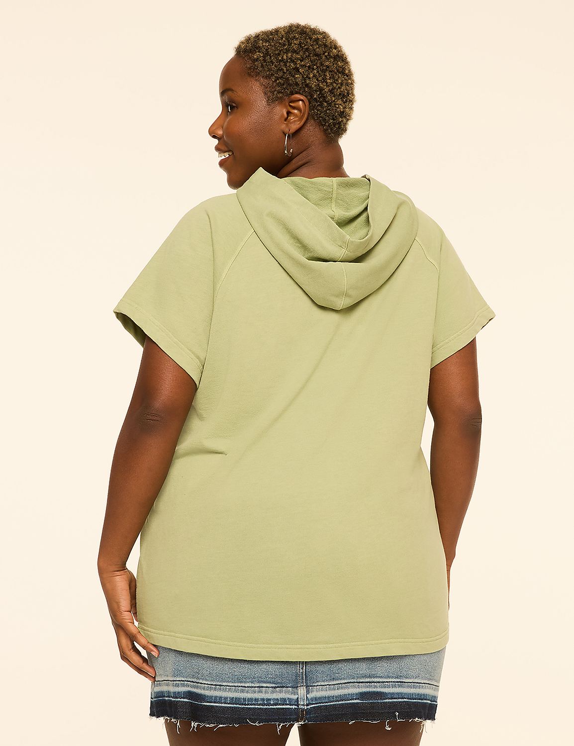 A woman in a light green short-sleeved hoodie and denim skirt stands against a plain, light-colored background. Product Image 2