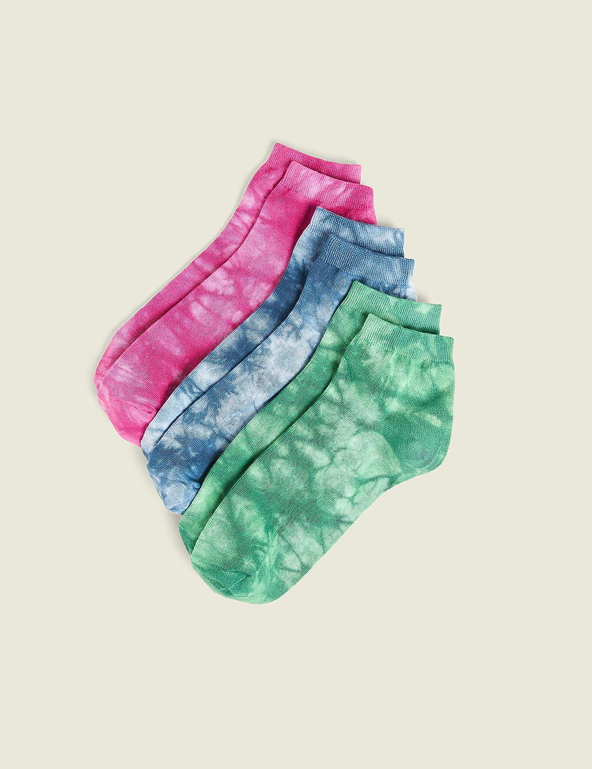 Four tie-dye ankle socks in pink, blue, and green are arranged diagonally on a plain, light-colored background. Product Image 1