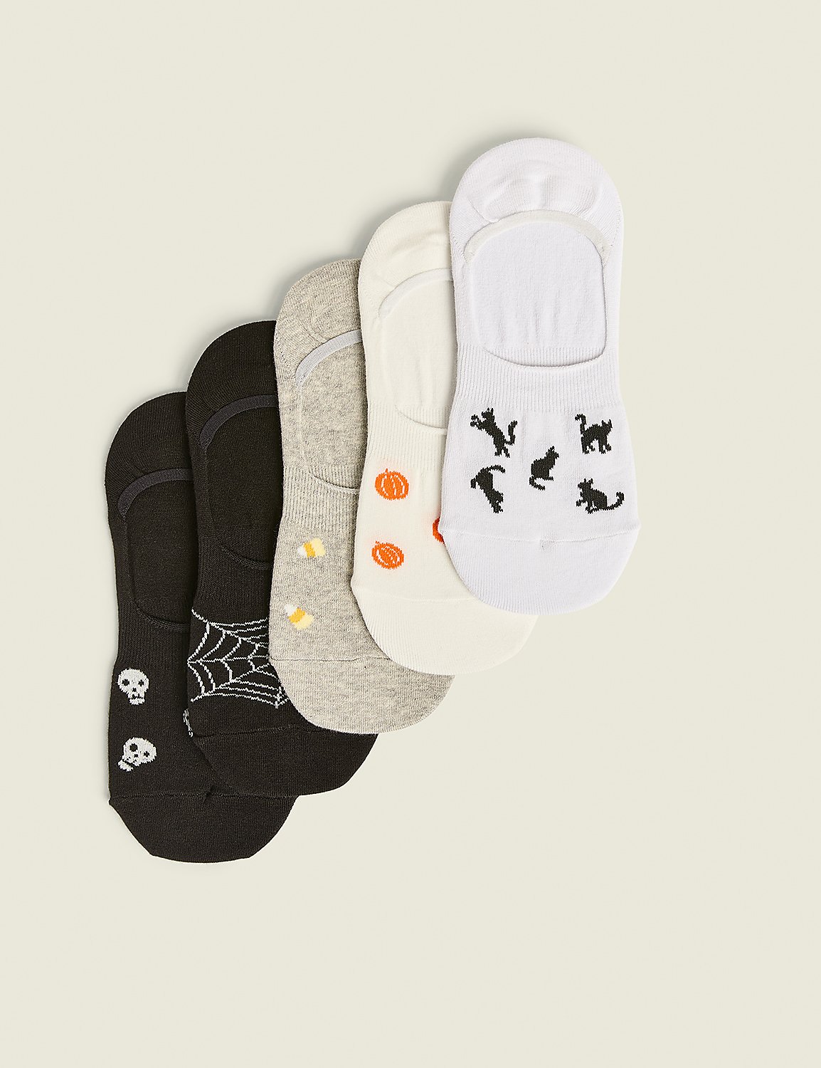 Five no-show socks with Halloween-themed patterns like skulls, spiderwebs, pumpkins, and black cats are arranged diagonally against a plain, light-colored background. Product Image 1