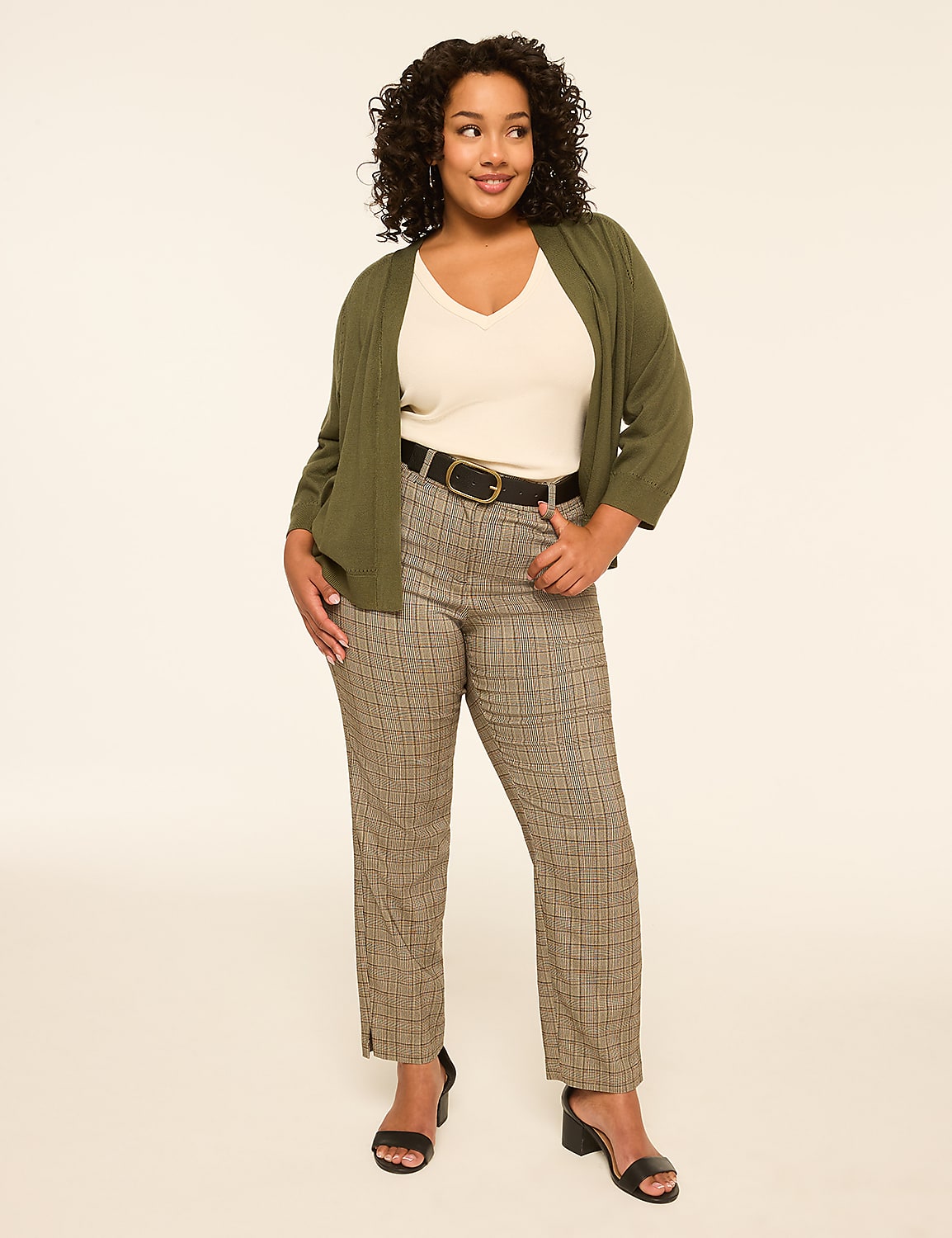 A woman in a green cardigan and plaid pants stands against a plain, light-colored background. Product Image 3