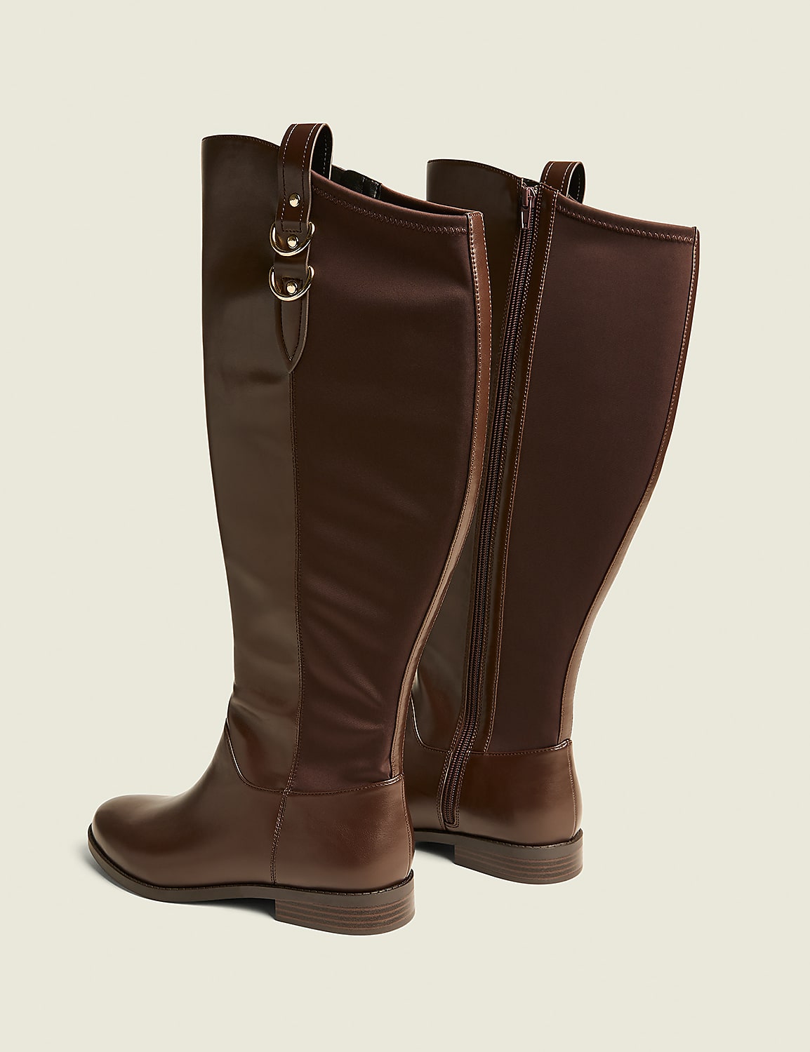 Two brown leather knee-high boots with gold buckle accents stand on a plain, light brown background. Product Image 2