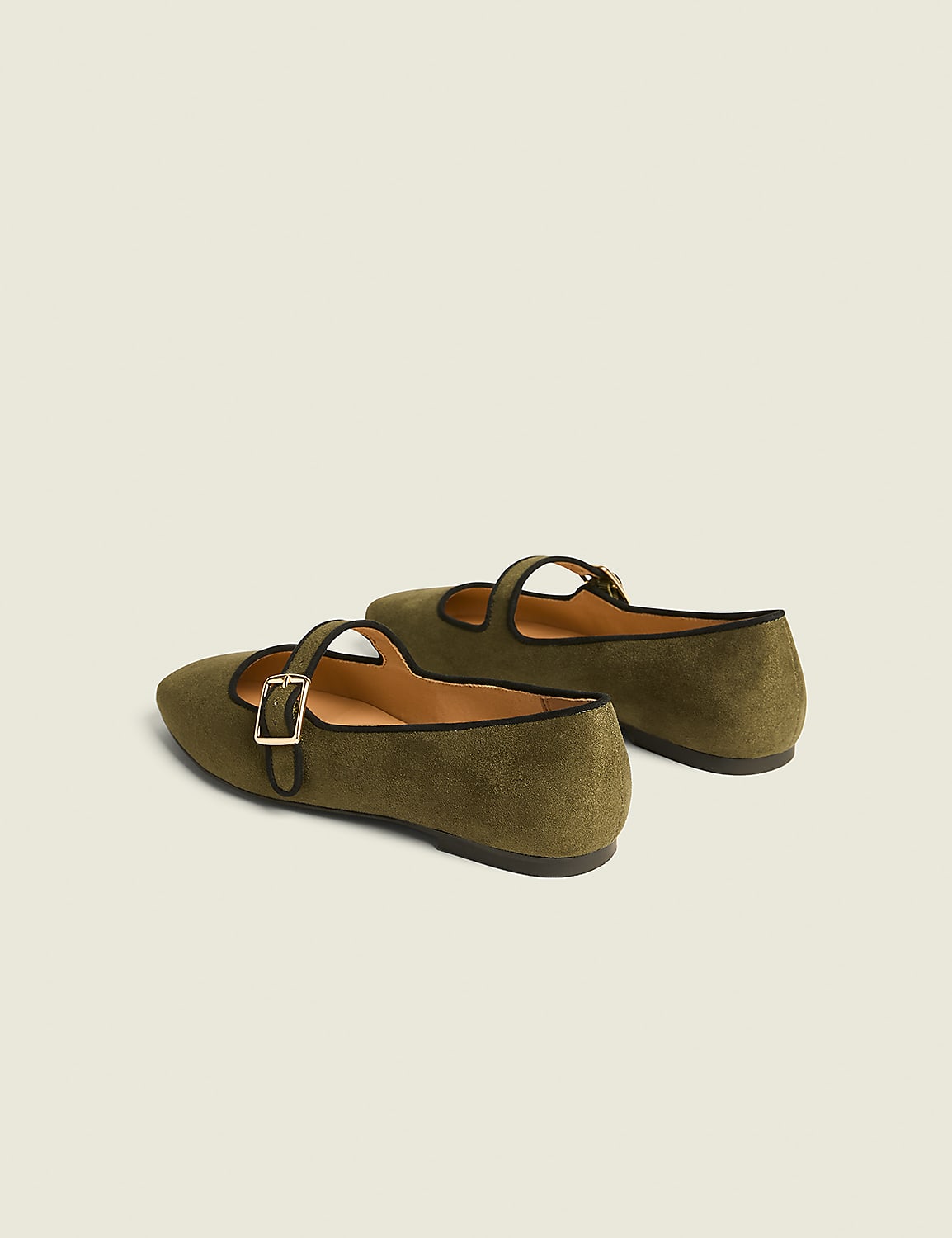 A pair of olive green Mary Jane flats with black trim and gold buckles rests on a plain, light gray background. Product Image 2