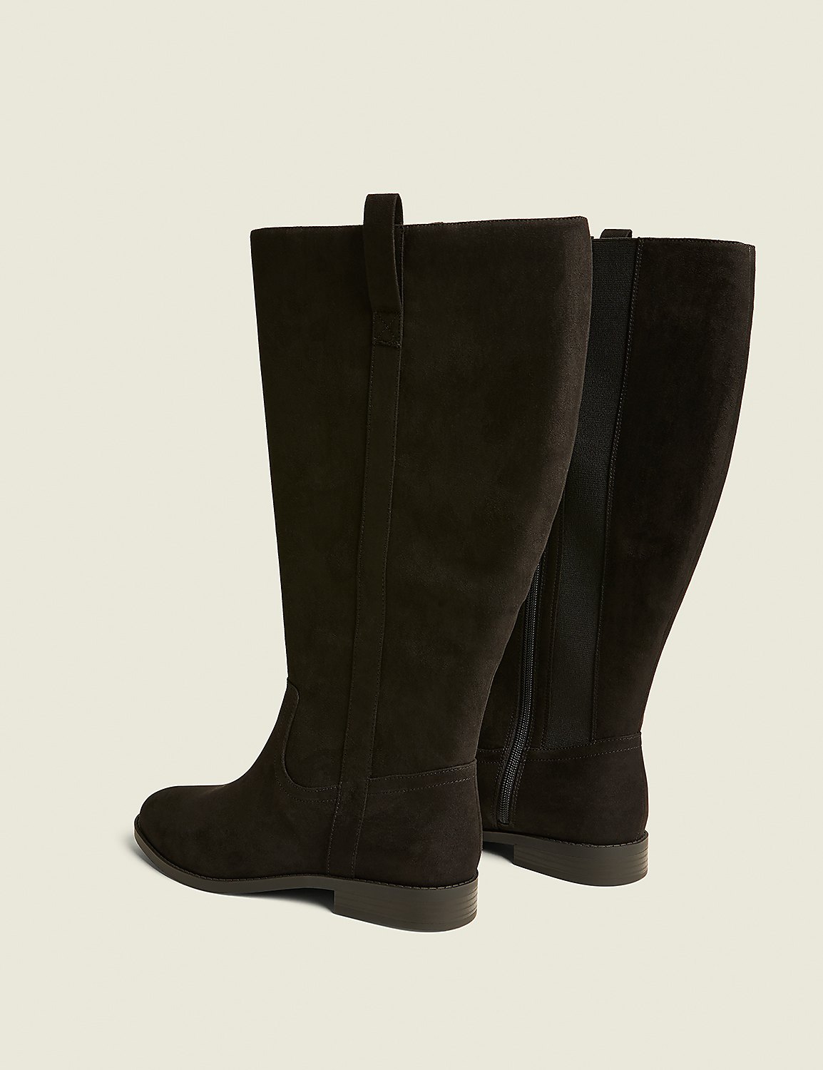 A pair of dark brown, knee-high boots with a flat sole are displayed against a plain, light beige background. Product Image 2