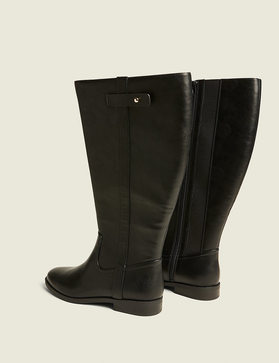 A pair of black leather knee-high boots with a buckle detail are displayed against a plain, light-colored background. Product Image 2
