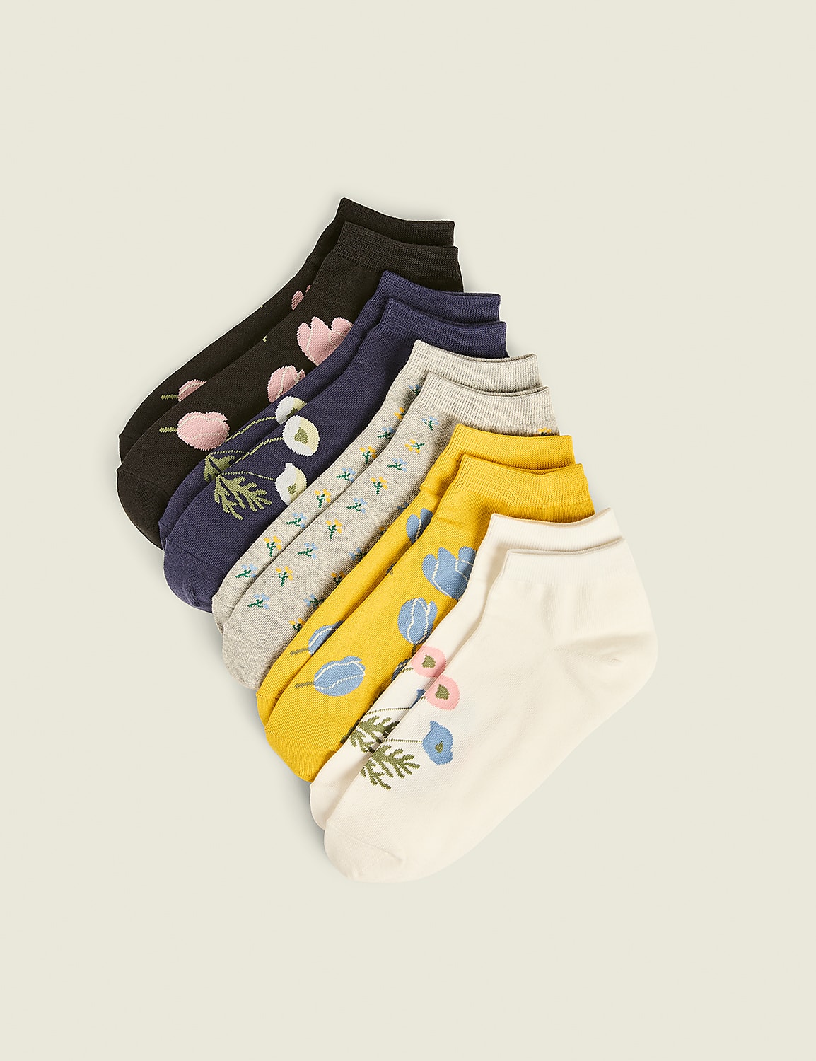 A fan of colorful, patterned ankle socks with floral designs is arranged diagonally against a plain, light background. Product Image 1