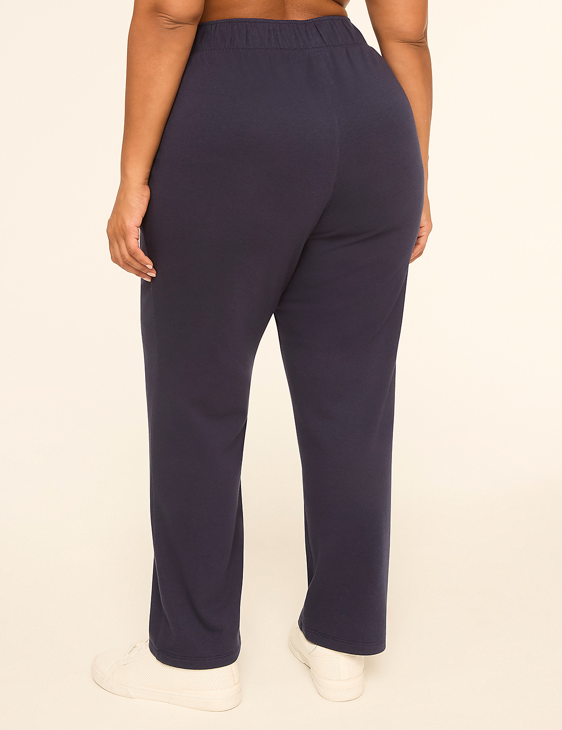 A person wearing navy blue sweatpants and white sneakers stands against a plain, light-colored background. Product Image 2