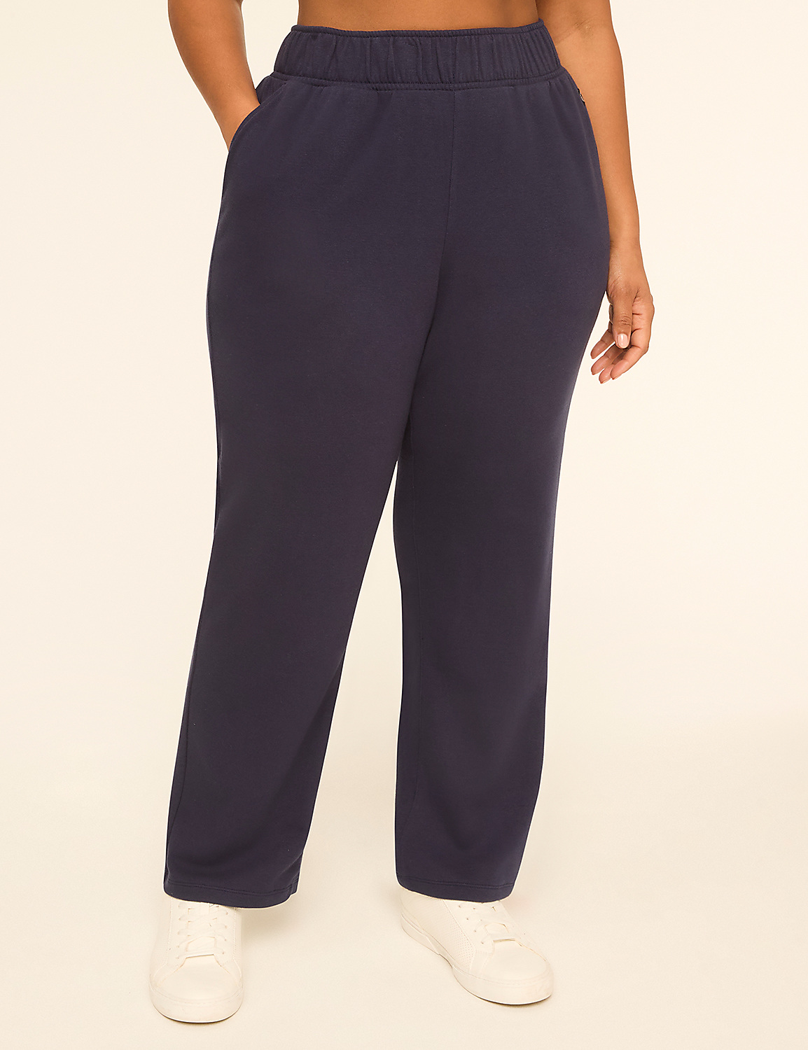 A person wearing navy blue sweatpants and white sneakers stands against a plain, light-colored background. Product Image 1