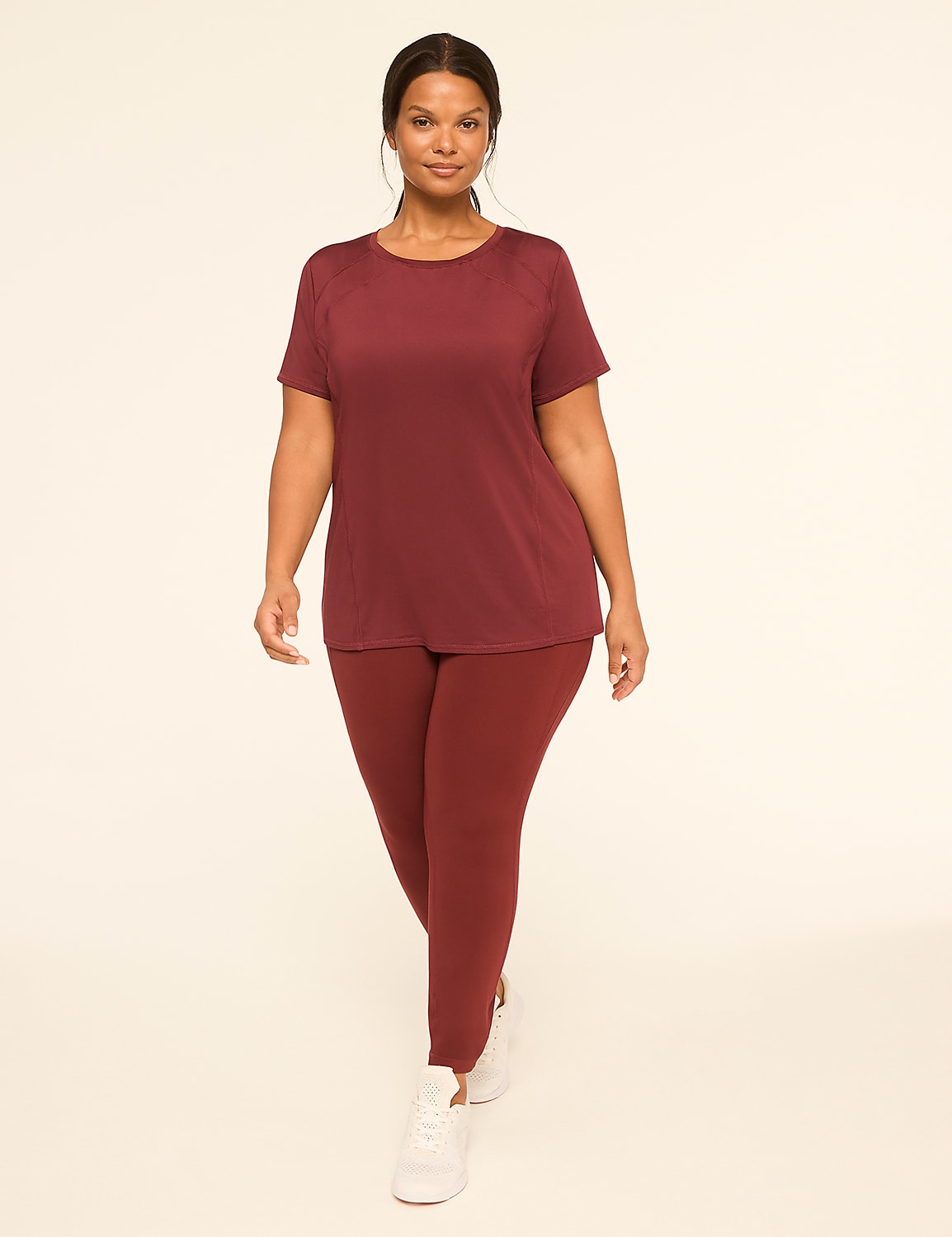 A woman in a maroon athletic outfit walks forward against a plain, light-colored background. Product Image 3