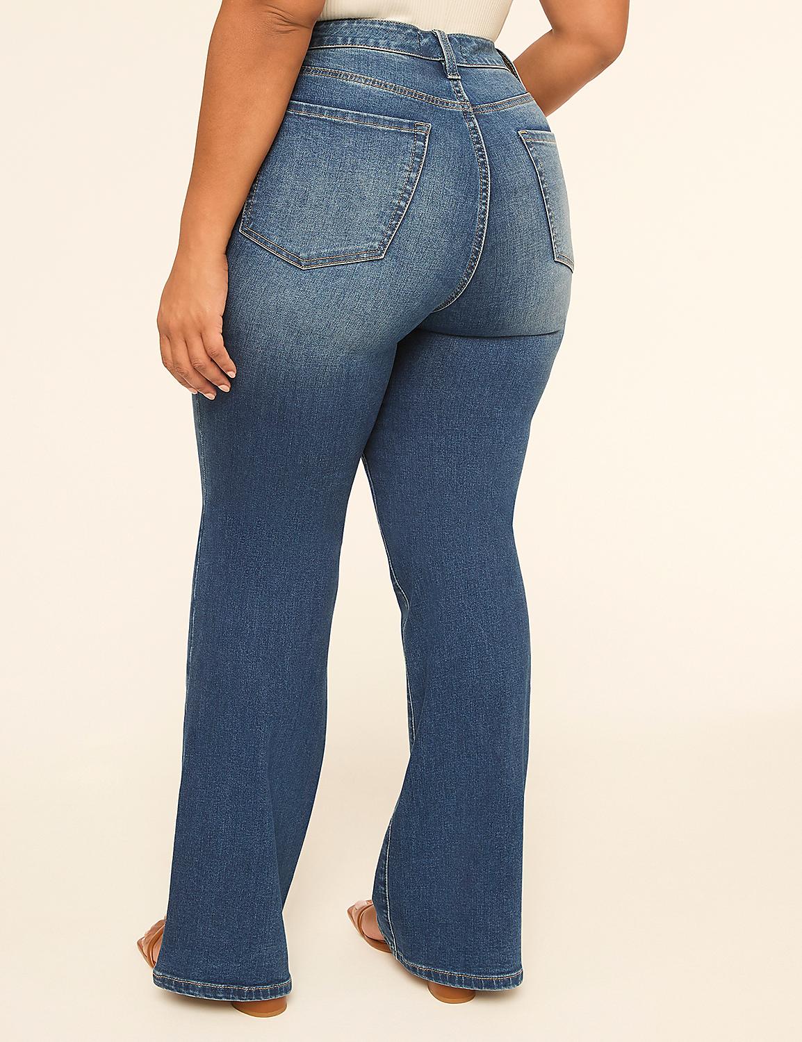 A person wearing flared blue jeans stands against a plain, light-colored background. Product Image 2