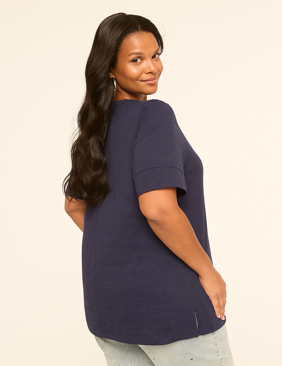 A woman in a navy blue shirt and jeans poses against a plain, light-colored background. Product Image 2