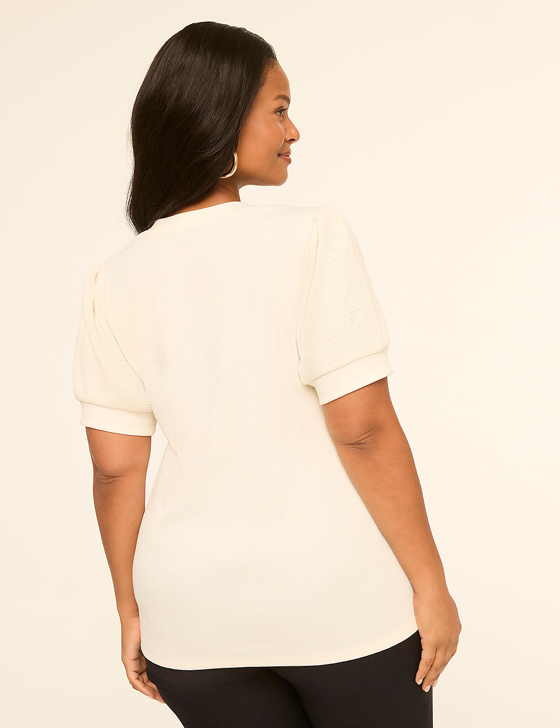 A woman in a cream-colored puff-sleeve top and black pants stands against a plain, light-colored background. Product Image 2