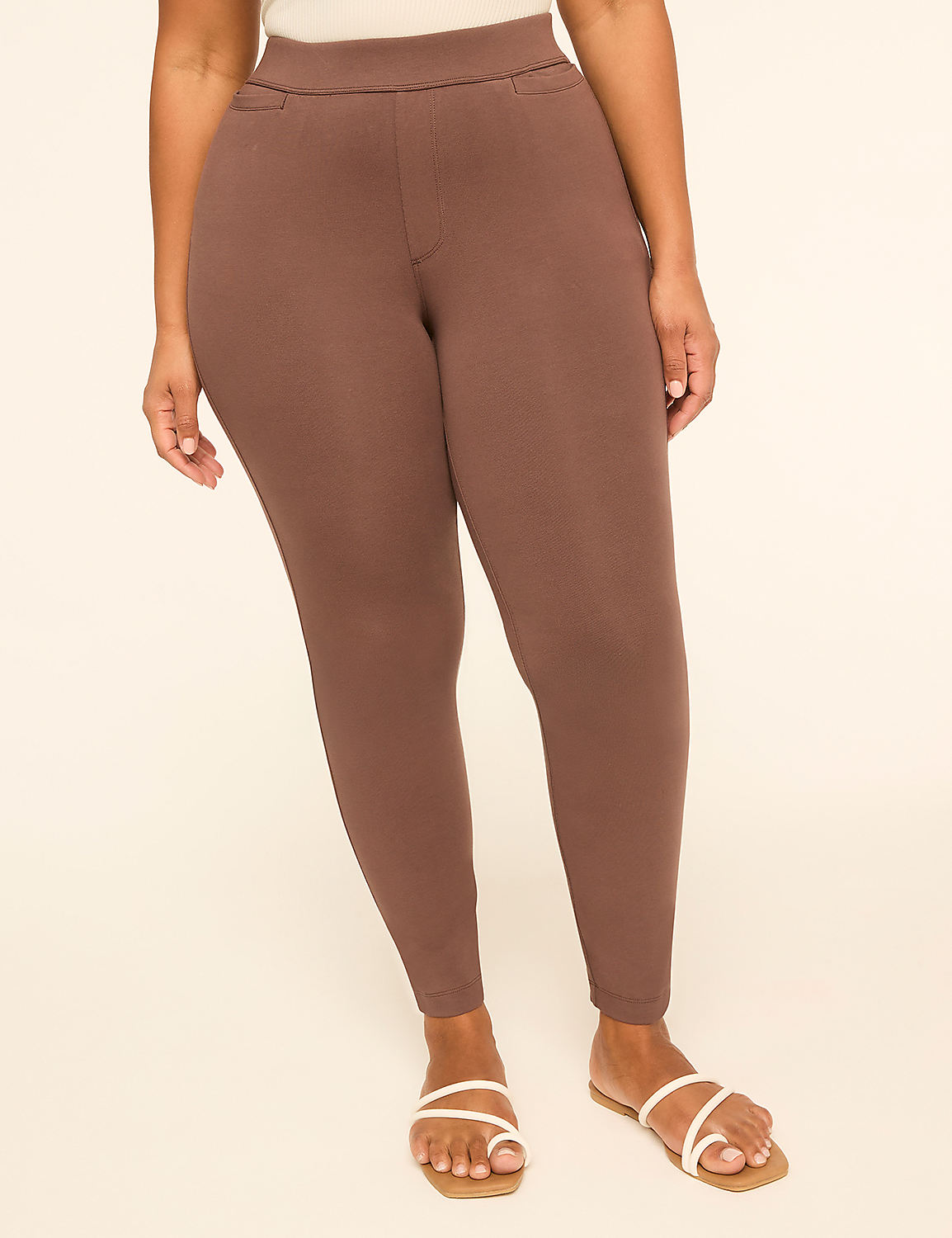 A person wearing brown leggings and white sandals stands against a plain, light-colored background. Product Image 1