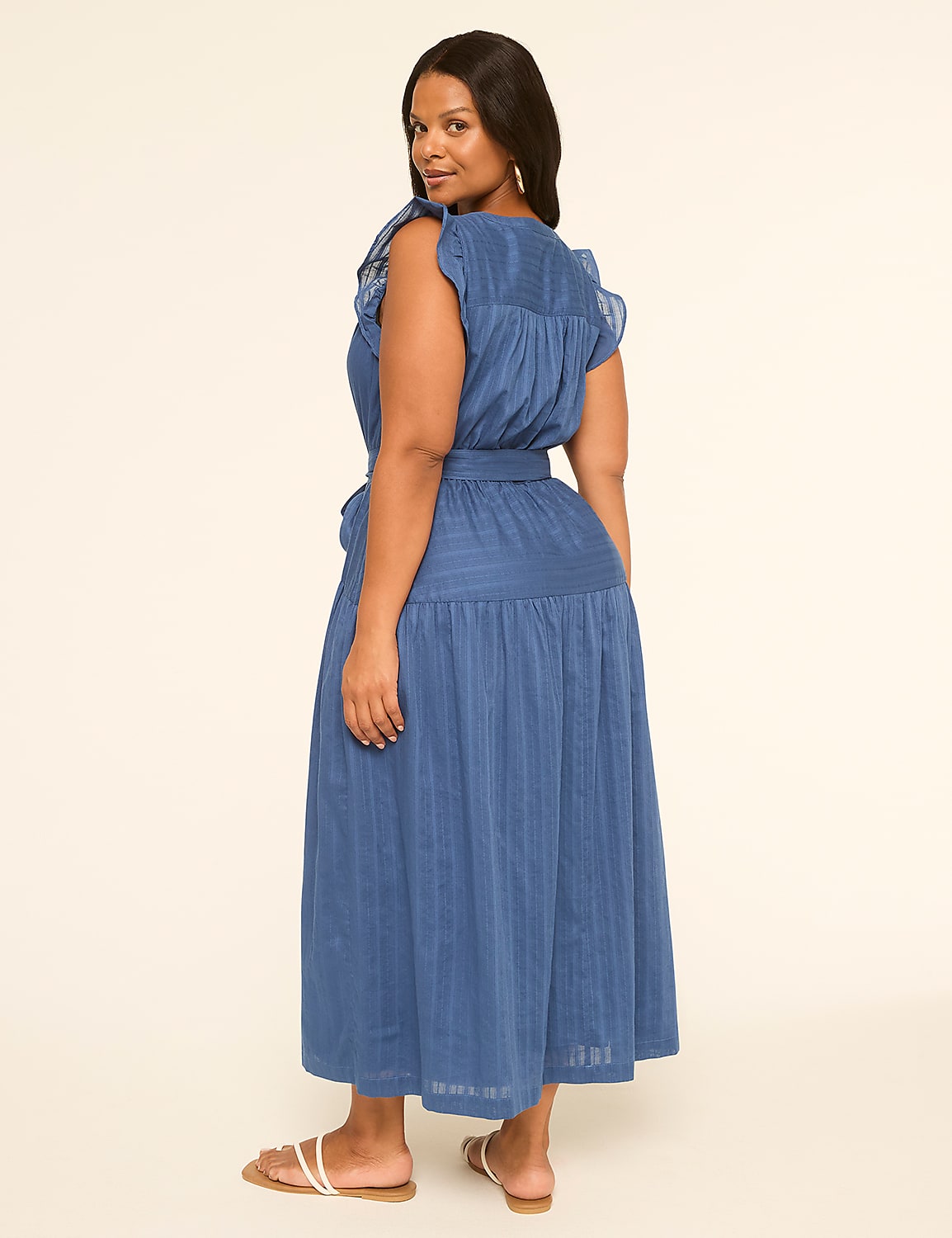 A woman in a blue dress stands against a plain, light-colored background. Product Image 2
