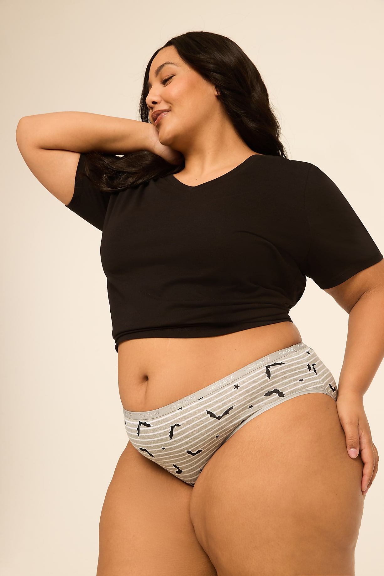 A woman in a black crop top and striped underwear poses against a plain, light-colored background. Product Image 7