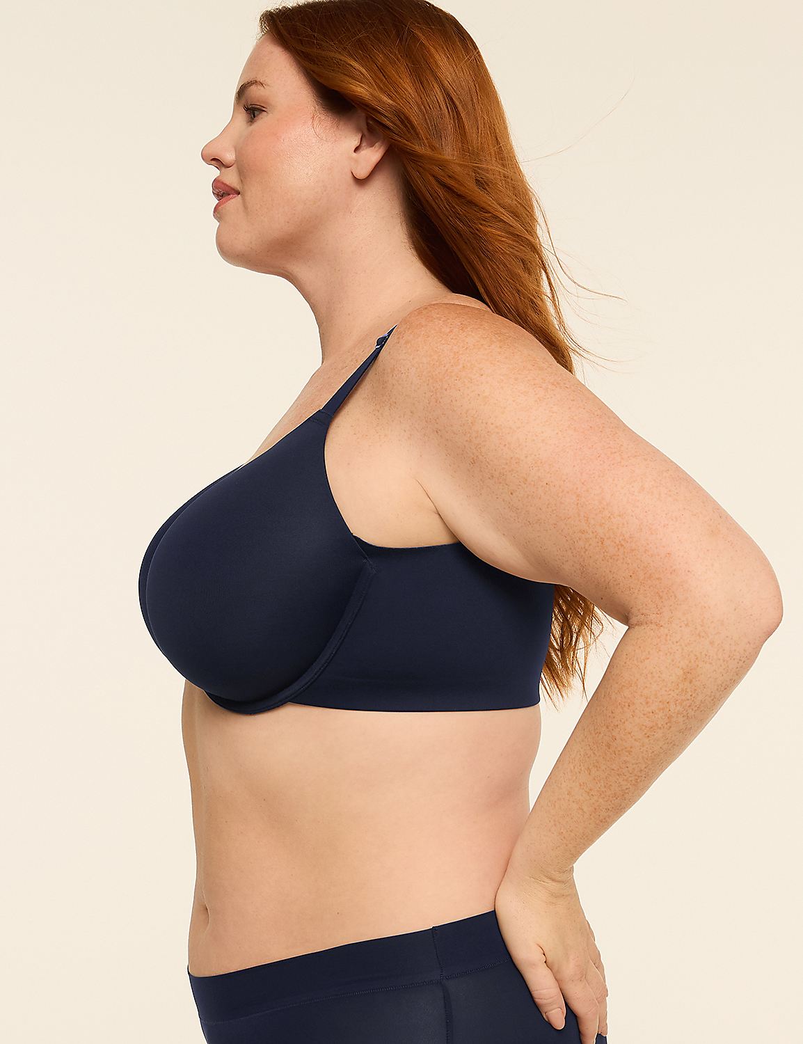 A woman with red hair in a navy bra and underwear stands against a plain, light-colored background. Product Image 3