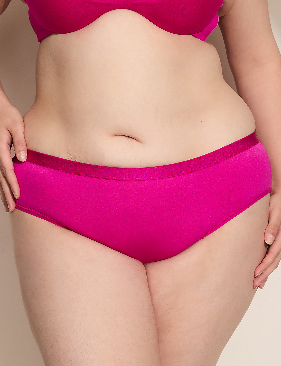 A person's torso, clad in bright pink underwear and bra, is centered against a plain, light-colored background. Product Image 1