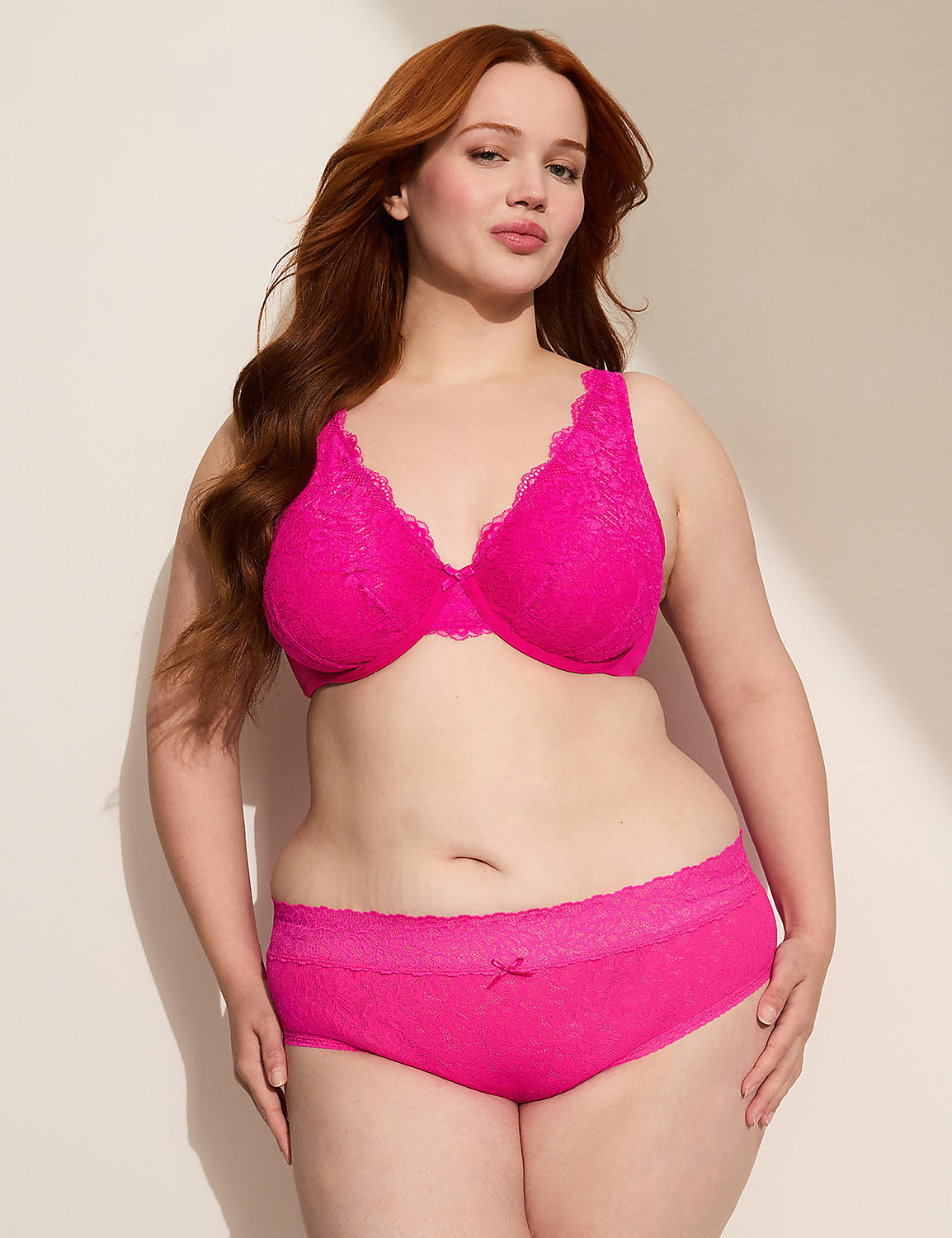 A woman with red hair poses in bright pink lace lingerie against a plain, light-colored background. Product Image 3