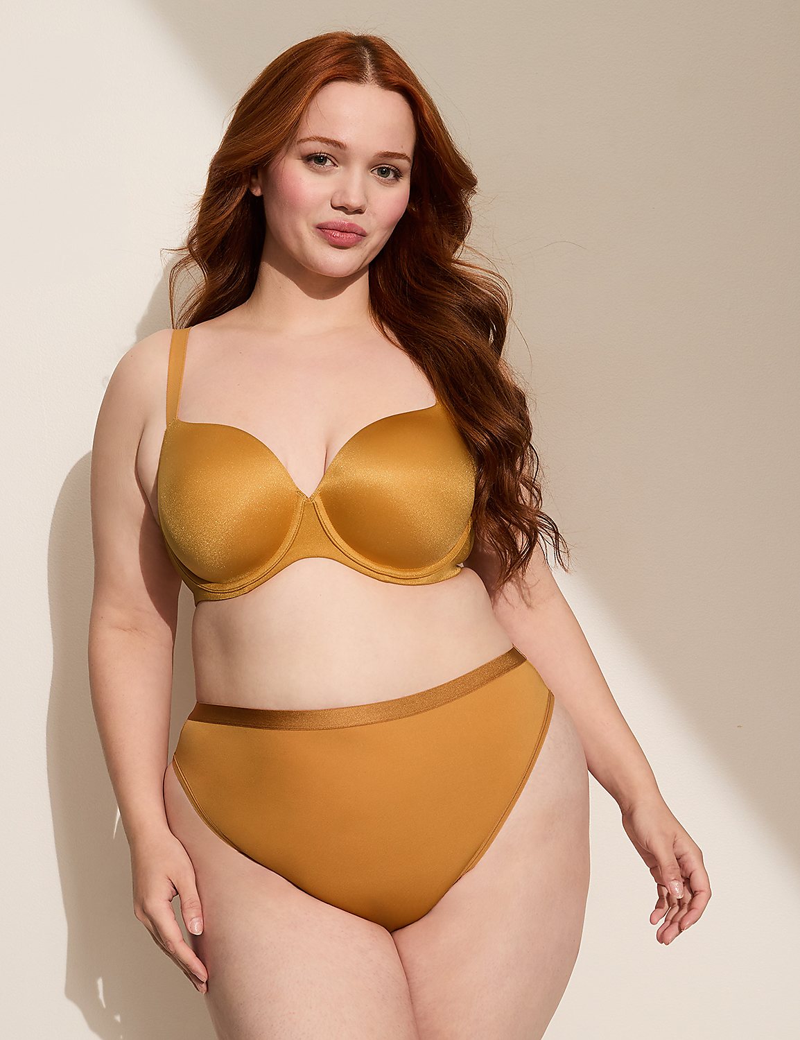 A woman with red hair poses in a mustard-colored bra and underwear against a plain, light-colored background with soft shadows. Product Image 3