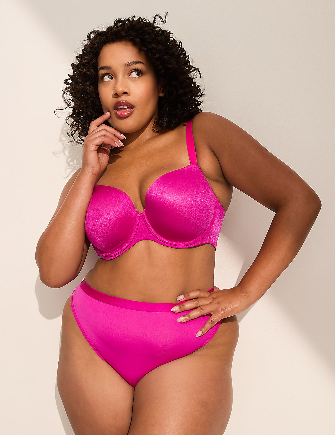A woman in a bright pink bra and underwear poses against a plain, light-colored wall. Product Image 4
