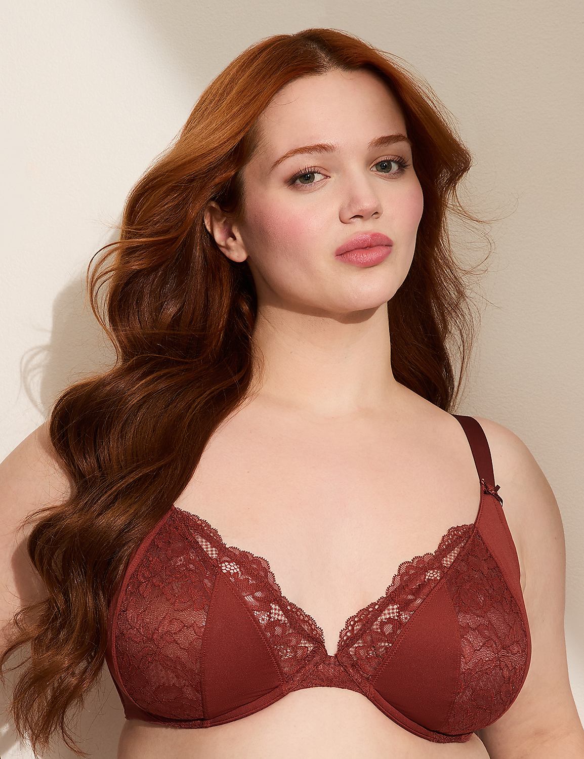 A woman with long, wavy red hair poses in a rust-colored lace bra against a plain, light-colored background. Product Image 1