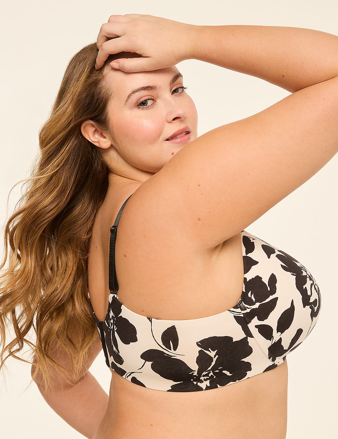 A woman with long, wavy blonde hair poses with her hand on her head, wearing a floral print bra against a plain, light background. Product Image 3